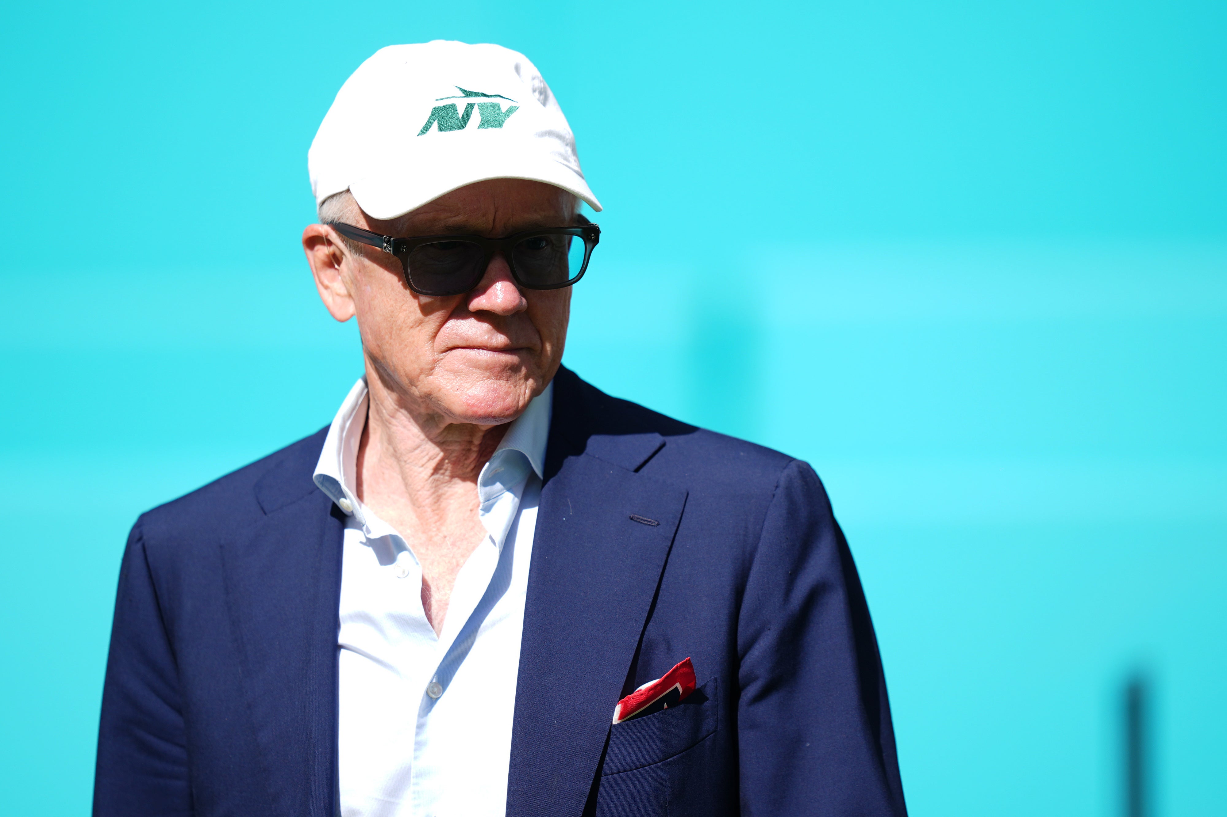 New York Jets owner Woody Johnson walks onto the field prior to the game between the Miami Dolphins and the New York Jets at Hard Rock Stadium.