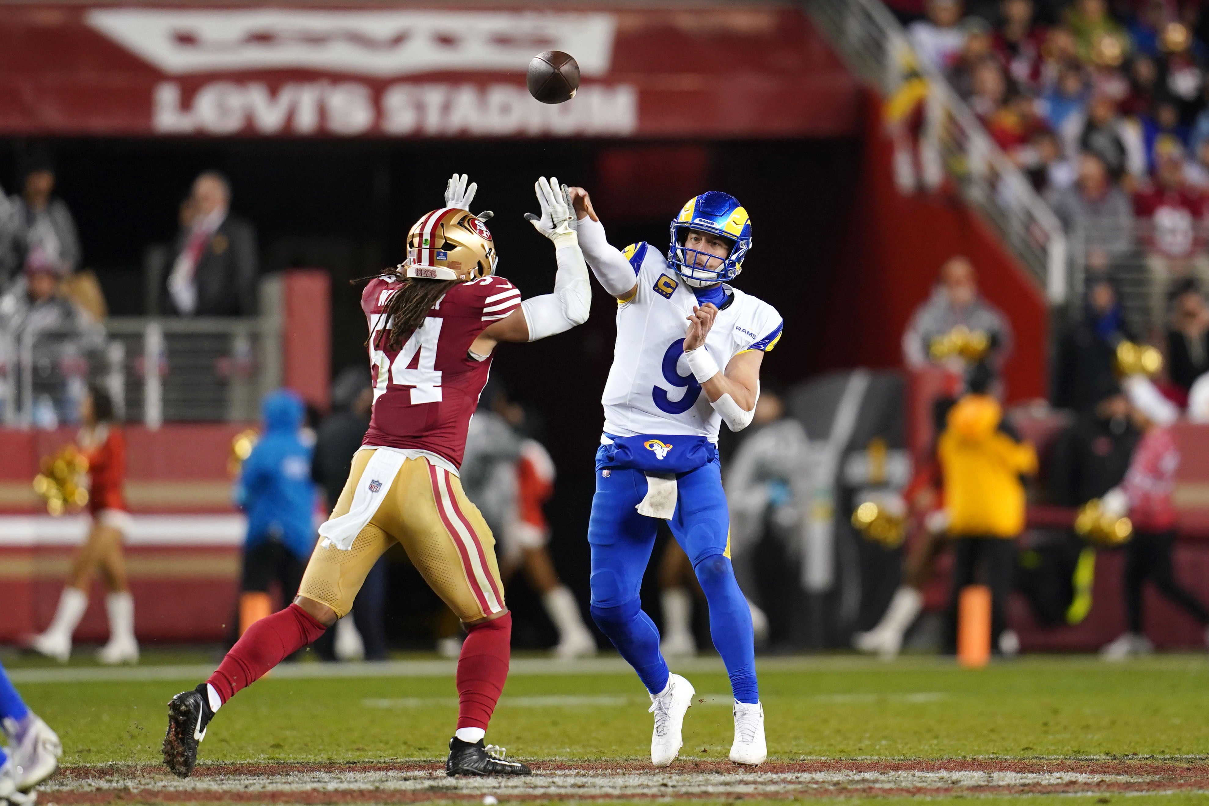 Los Angeles Rams quarterback Matthew Stafford (9) throws a pass over San Francisco 49ers linebacker Fred Warner (54) in the third quarter at Levi's Stadium.