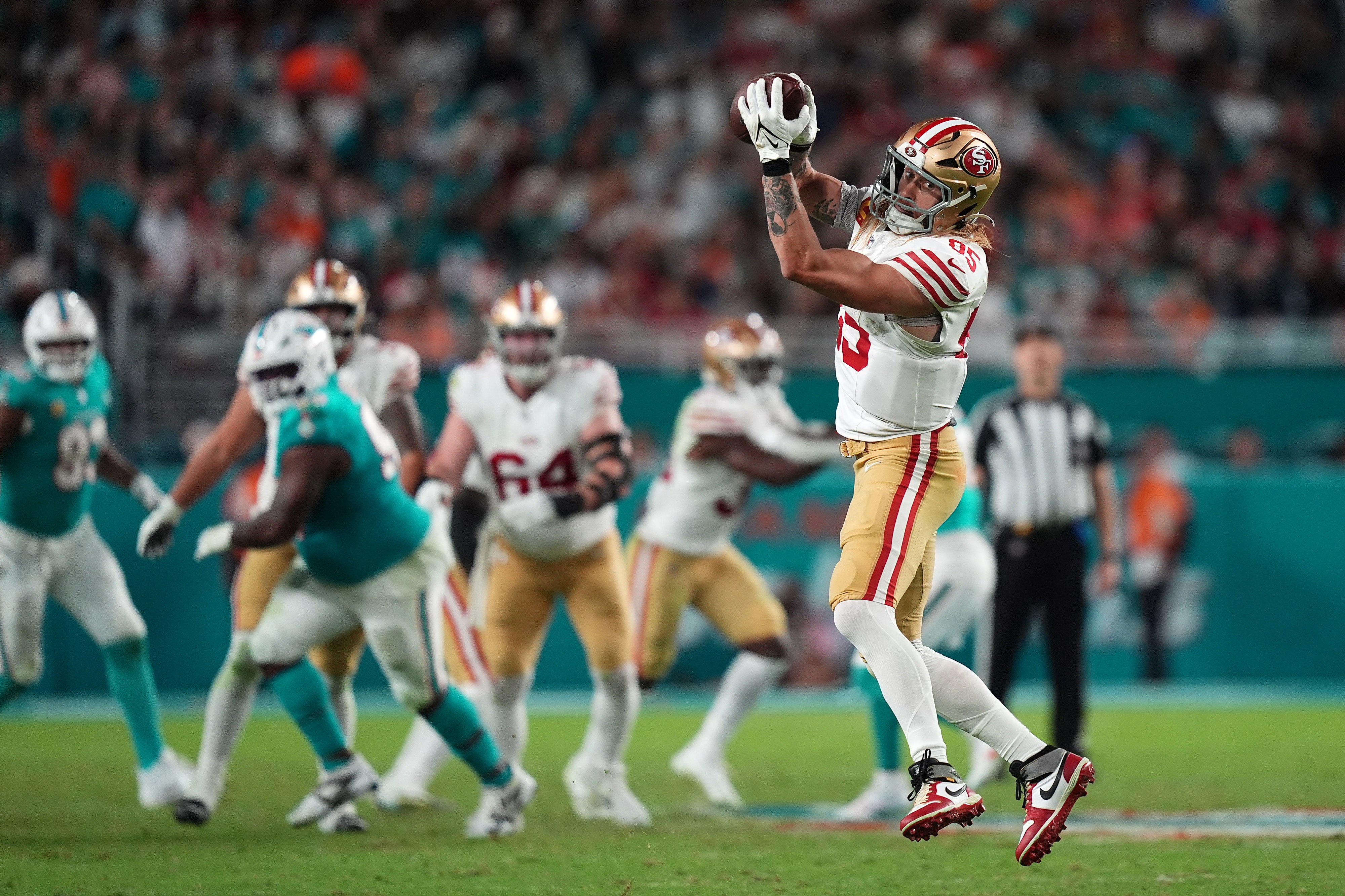San Francisco 49ers tight end George Kittle (85) makes a catch against the Miami Dolphins during second half at Hard Rock Stadium.