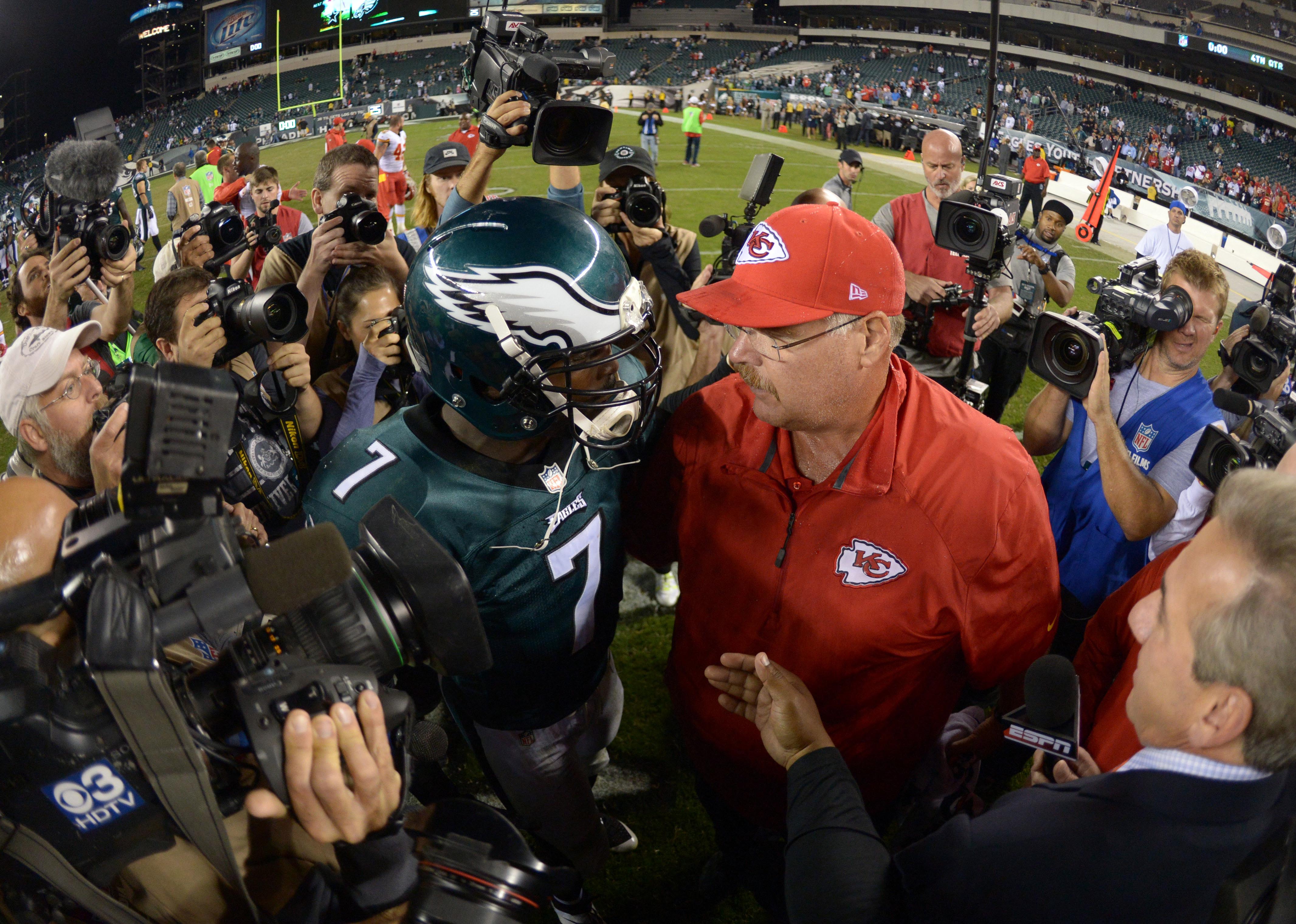 Sep 19, 2013; Philadelphia, PA, USA; Philadelphia Eagles quarterback Michael Vick (7) and Kansas City Chiefs coach Andy Reid embrace at the end of the game at Lincoln Financial Field. The Chiefs defeated the Eagles 26-16.
