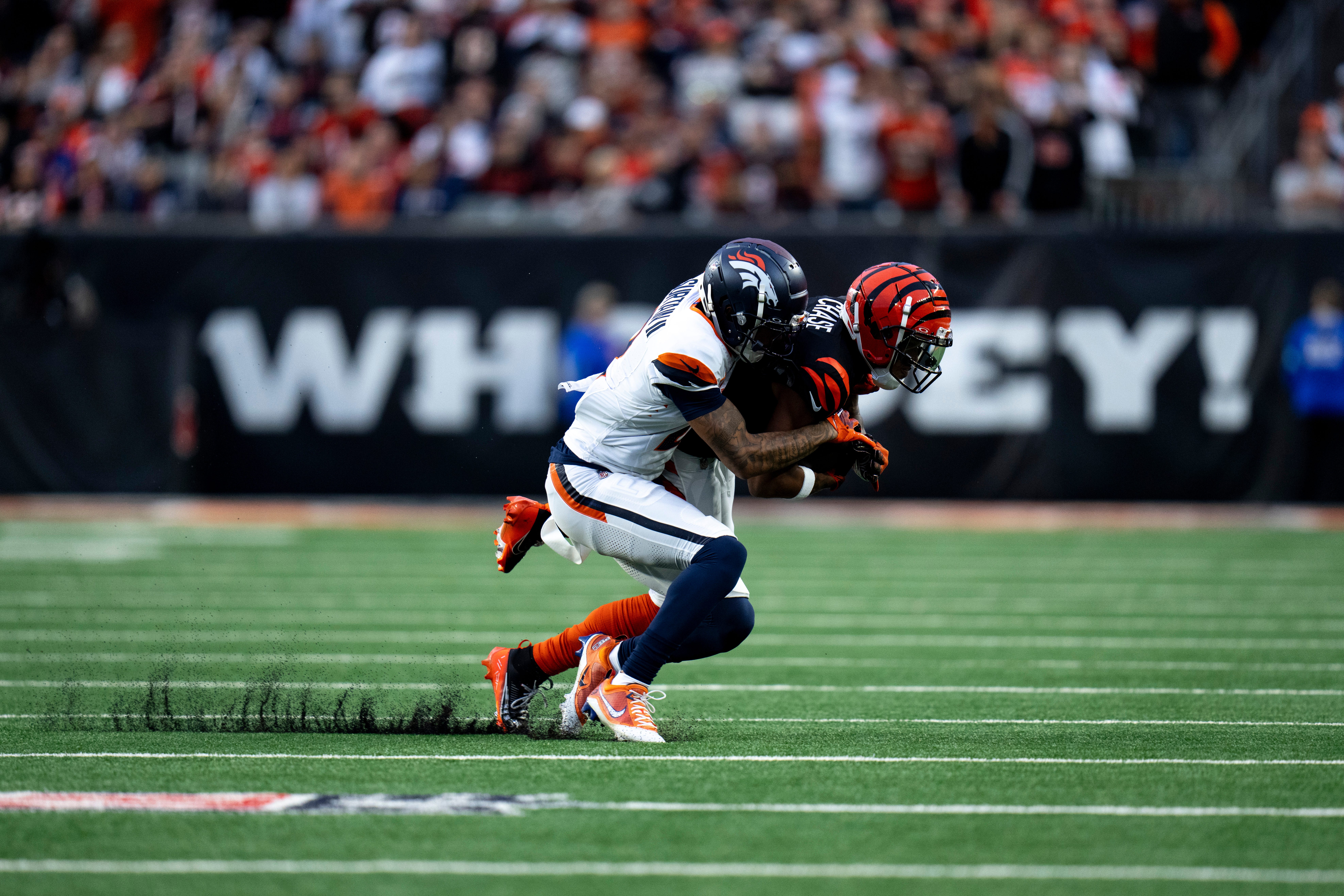 Broncos cornerback Pat Surtain II (2) tackles Bengals wide receiver Ja'Marr Chase (1)