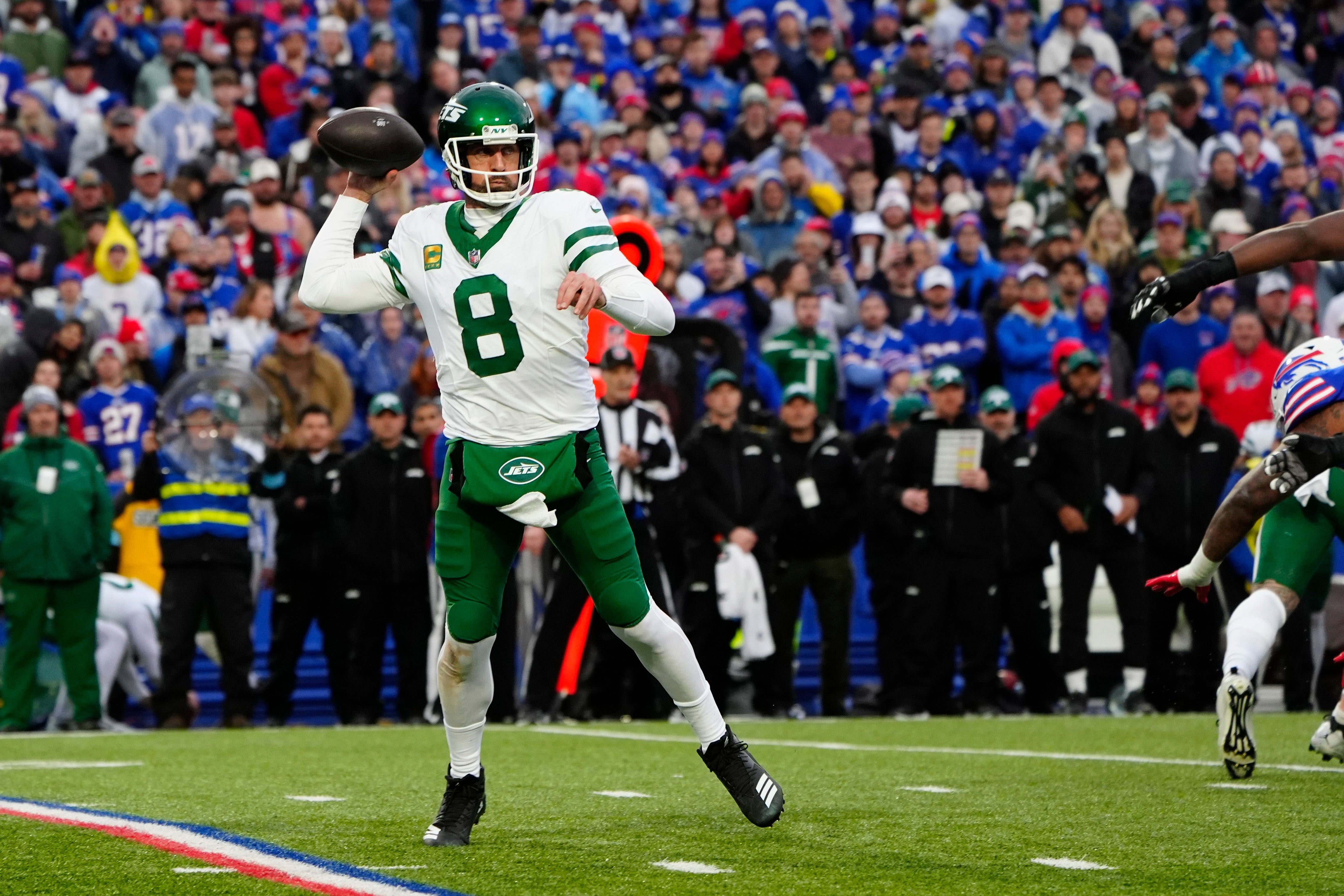New York Jets quarterback Aaron Rodgers (8) throws the ball against the Buffalo Bills during the first half at Highmark Stadium.