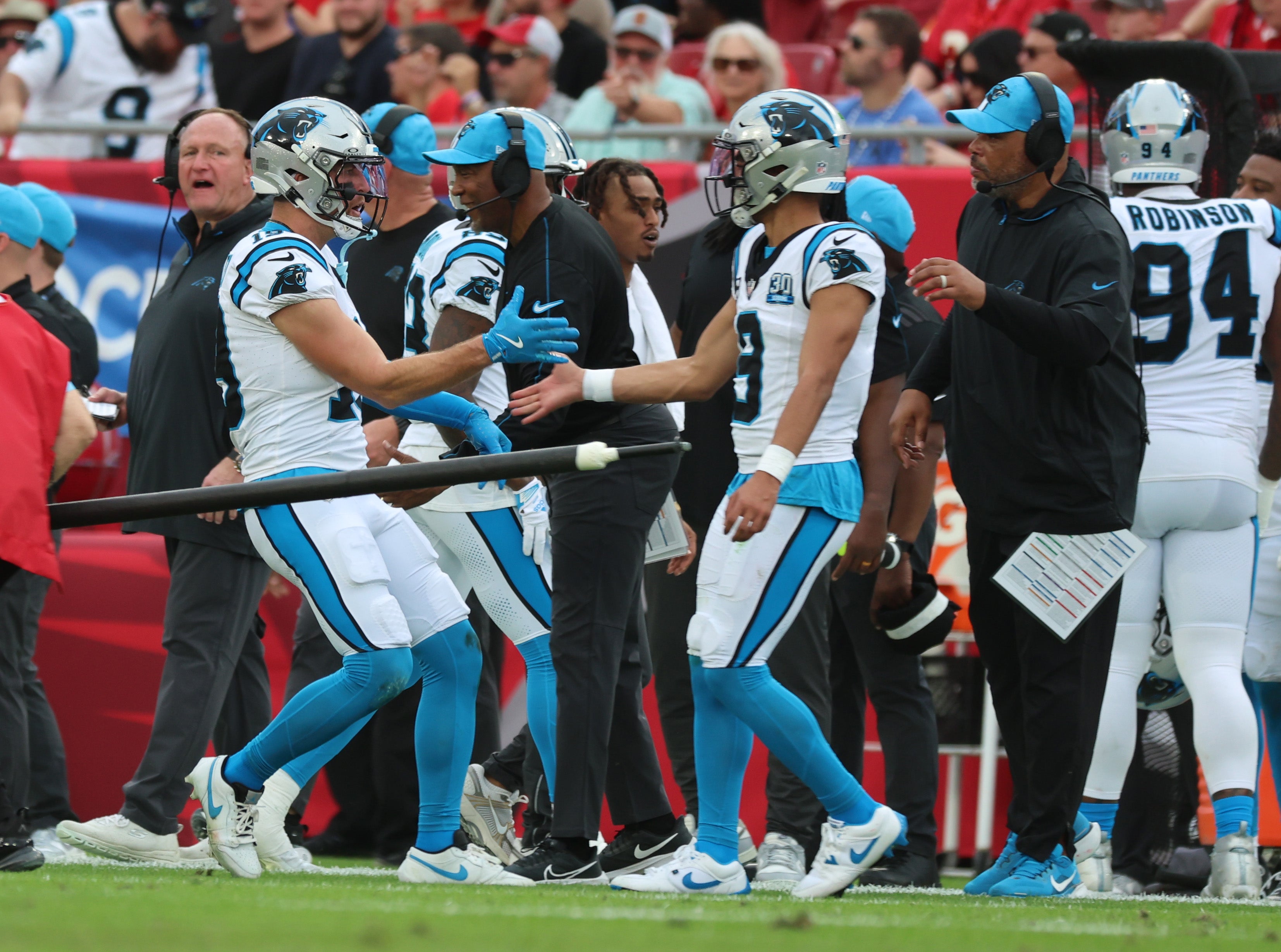 Panthers wide receiver Adam Thielen (19) is congratulated by quarterback Bryce Young (9) after he scored a touchdown against the Buccaneers.