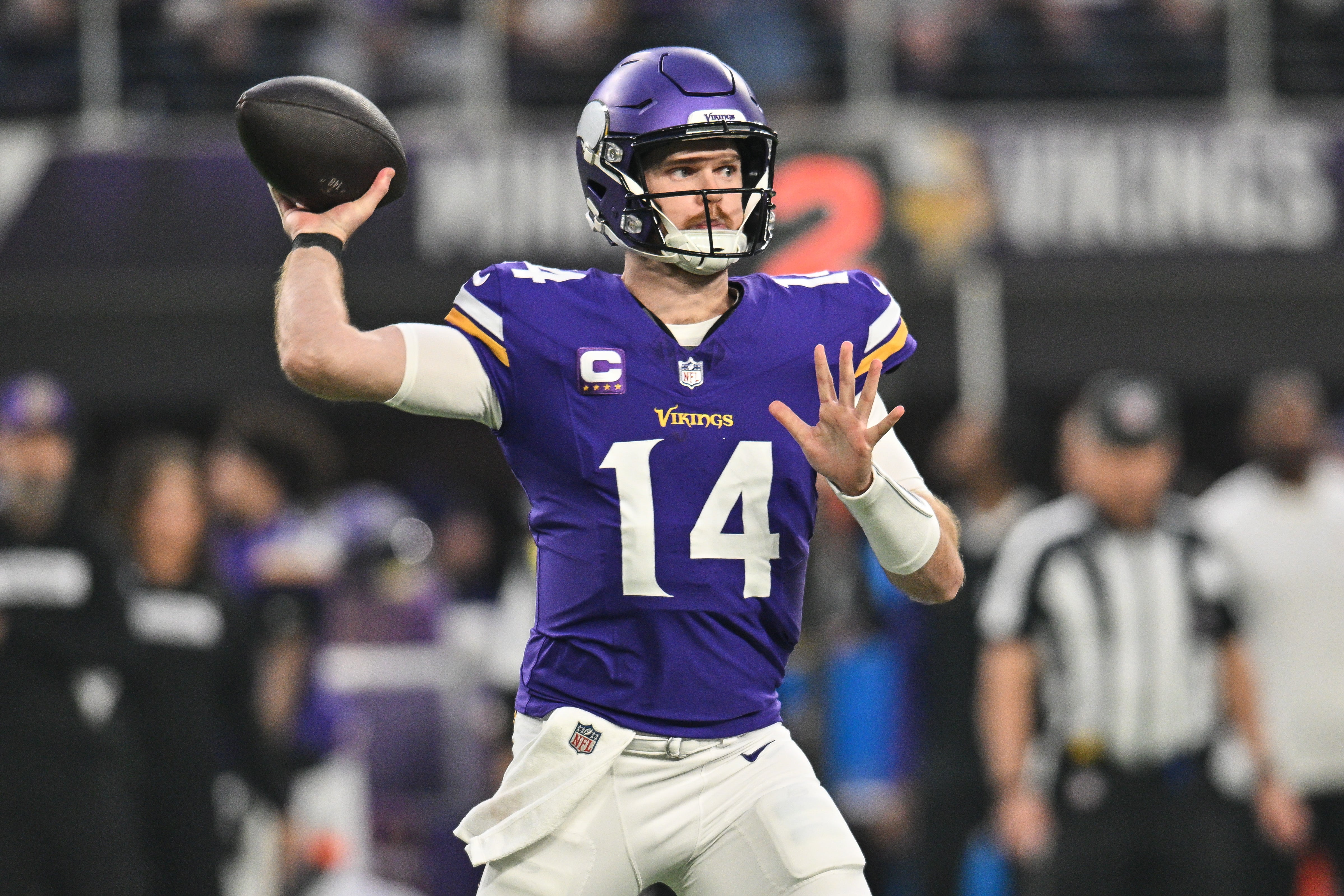 Dec 29, 2024; Minneapolis, Minnesota, USA; Minnesota Vikings quarterback Sam Darnold (14) throws a pass against the Green Bay Packers during the first quarter at U.S. Bank Stadium.