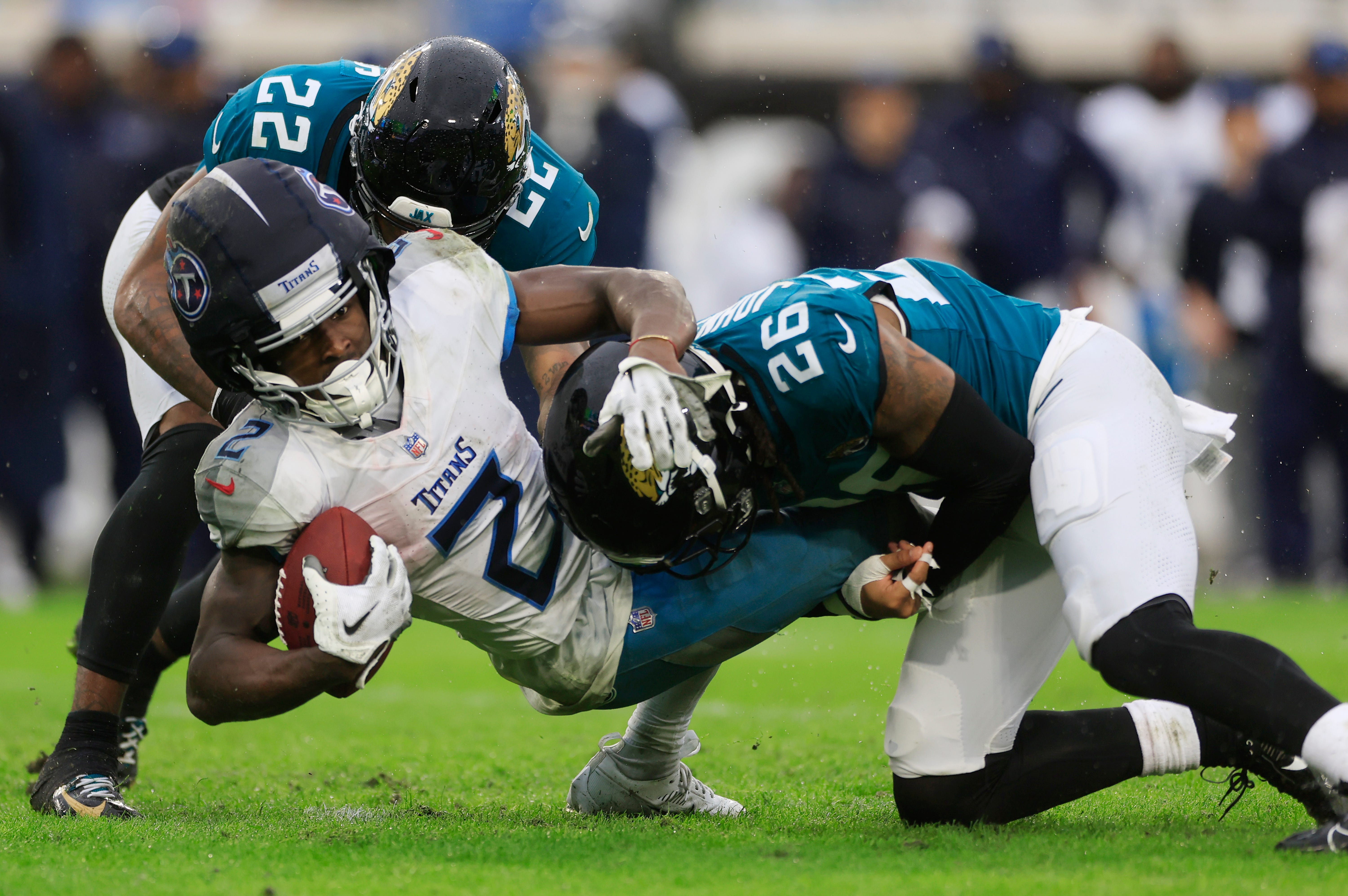 Jacksonville Jaguars cornerback Jarrian Jones (22) and safety Antonio Johnson (26) combine to tackle Tennessee Titans running back Tyjae Spears (2) during the second quarter of an NFL football matchup... Corey Perrine/Florida Times-Union-USA TODAY NETWORK via Imagn Images