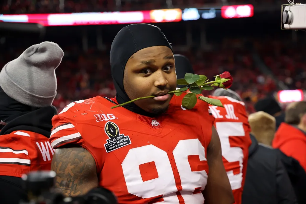 Ohio State Buckeyes defensive end Eddrick Houston (96) celebrates the win as he carries a rose after the game against the Tennessee Volunteers at Ohio Stadium.