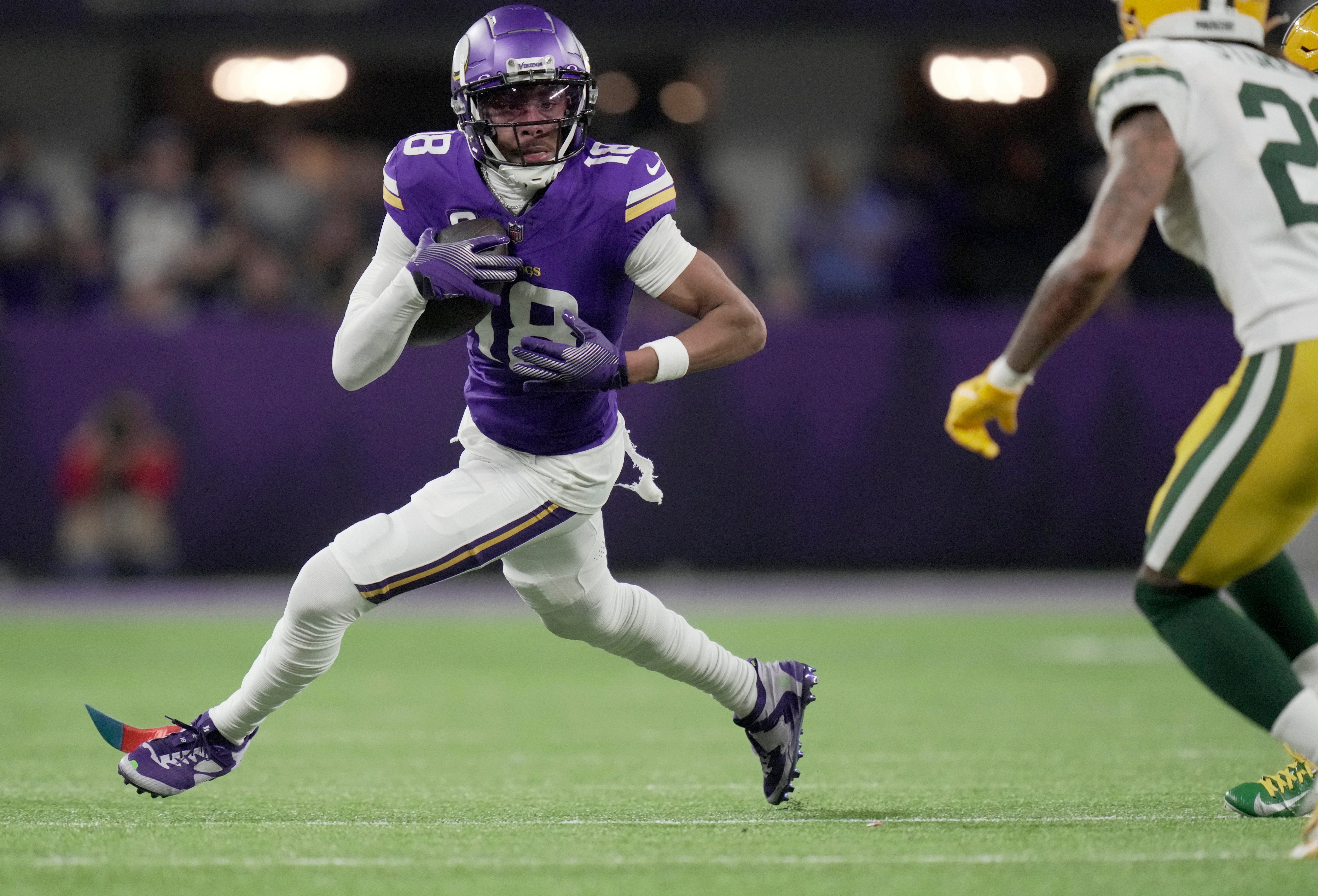 Minnesota Vikings wide receiver Justin Jefferson (18) looks for running room after a reception against the Green Bay Packers at U.S. Bank Stadium.