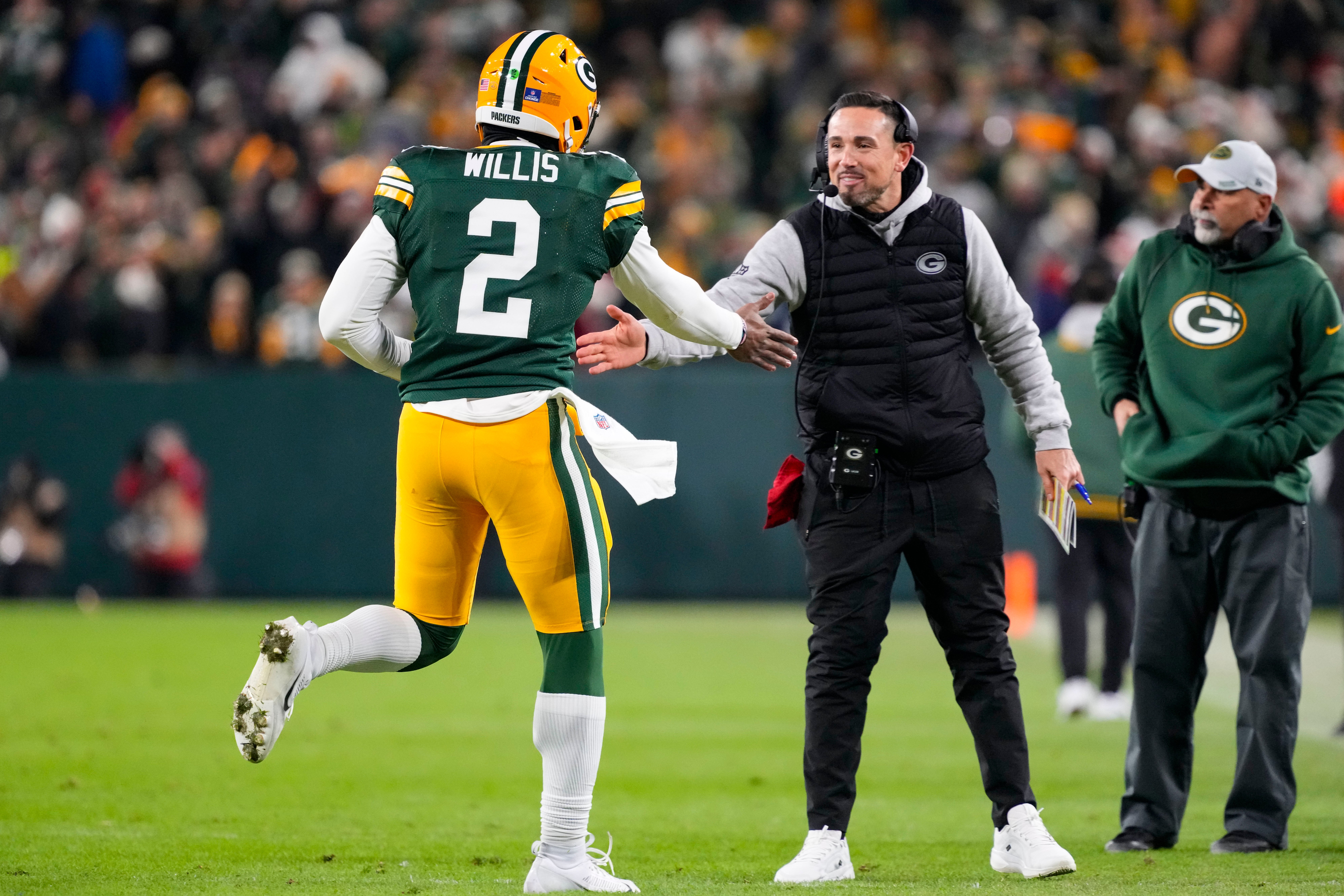 Green Bay Packers head coach Matt LaFleur greets quarterback Malik Willis (2) following a touchdown during the fourth quarter against the New Orleans Saints at Lambeau Field.