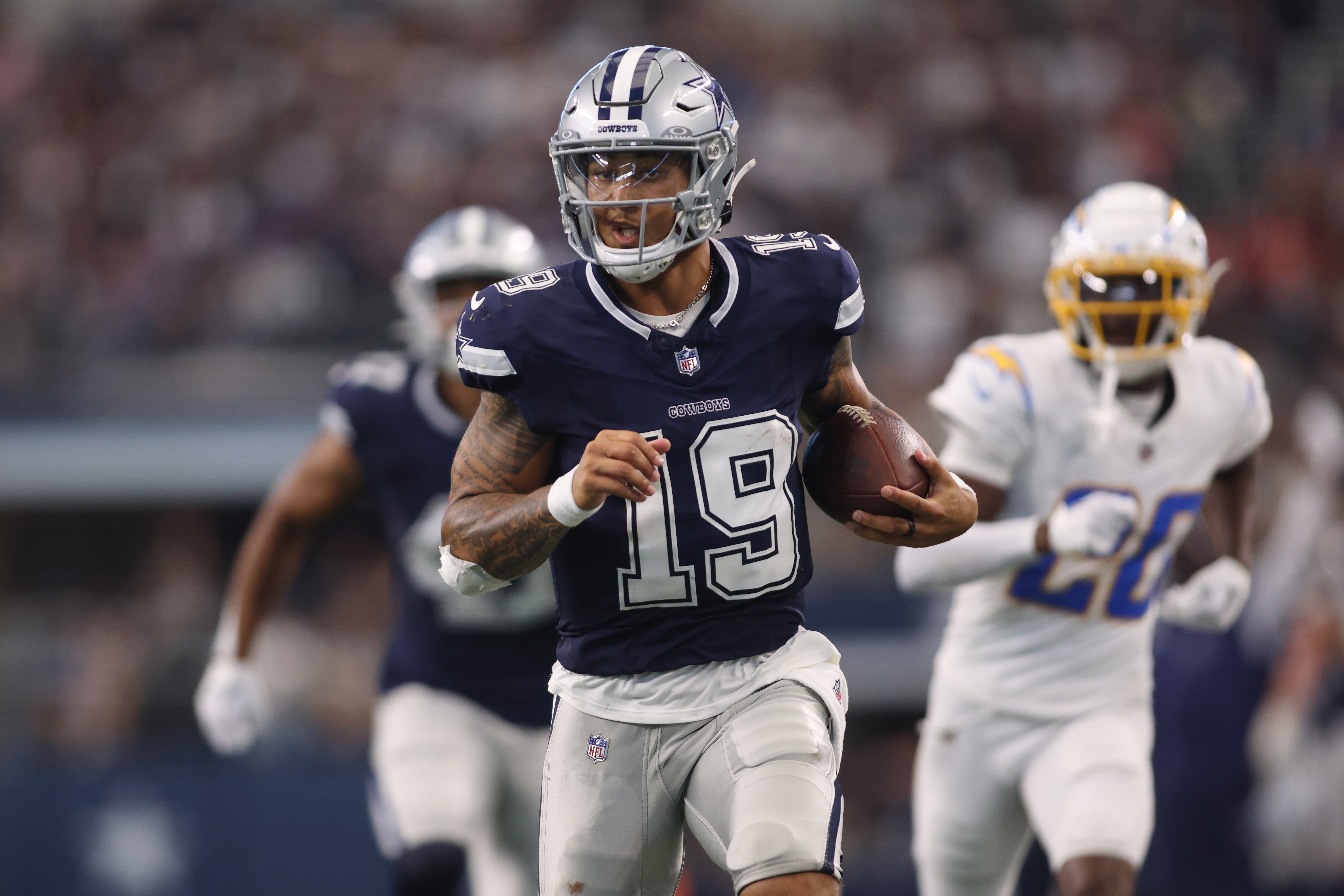 Dallas Cowboys quarterback Trey Lance (19) runs for a touchdown against the Los Angeles Chargers in the third quarter at AT&T Stadium.