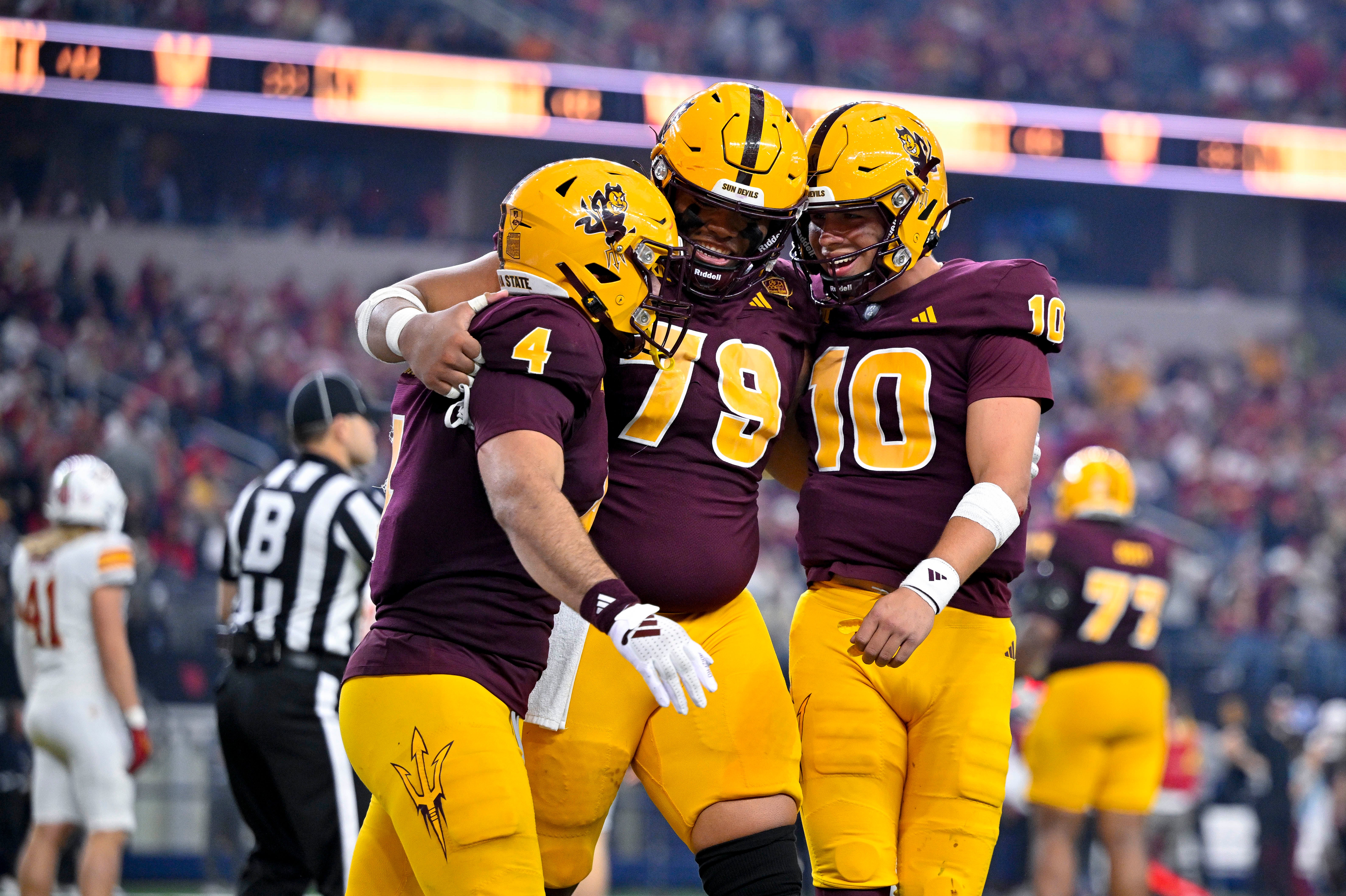 Arizona State Sun Devils running back Cam Skattebo (4) and offensive lineman Leif Fautanu (79) and quarterback Sam Leavitt (10) celebrate after Skattebo scores a rushing touchdown against the Iowa State Cyclones during the second half at AT&T Stadium.