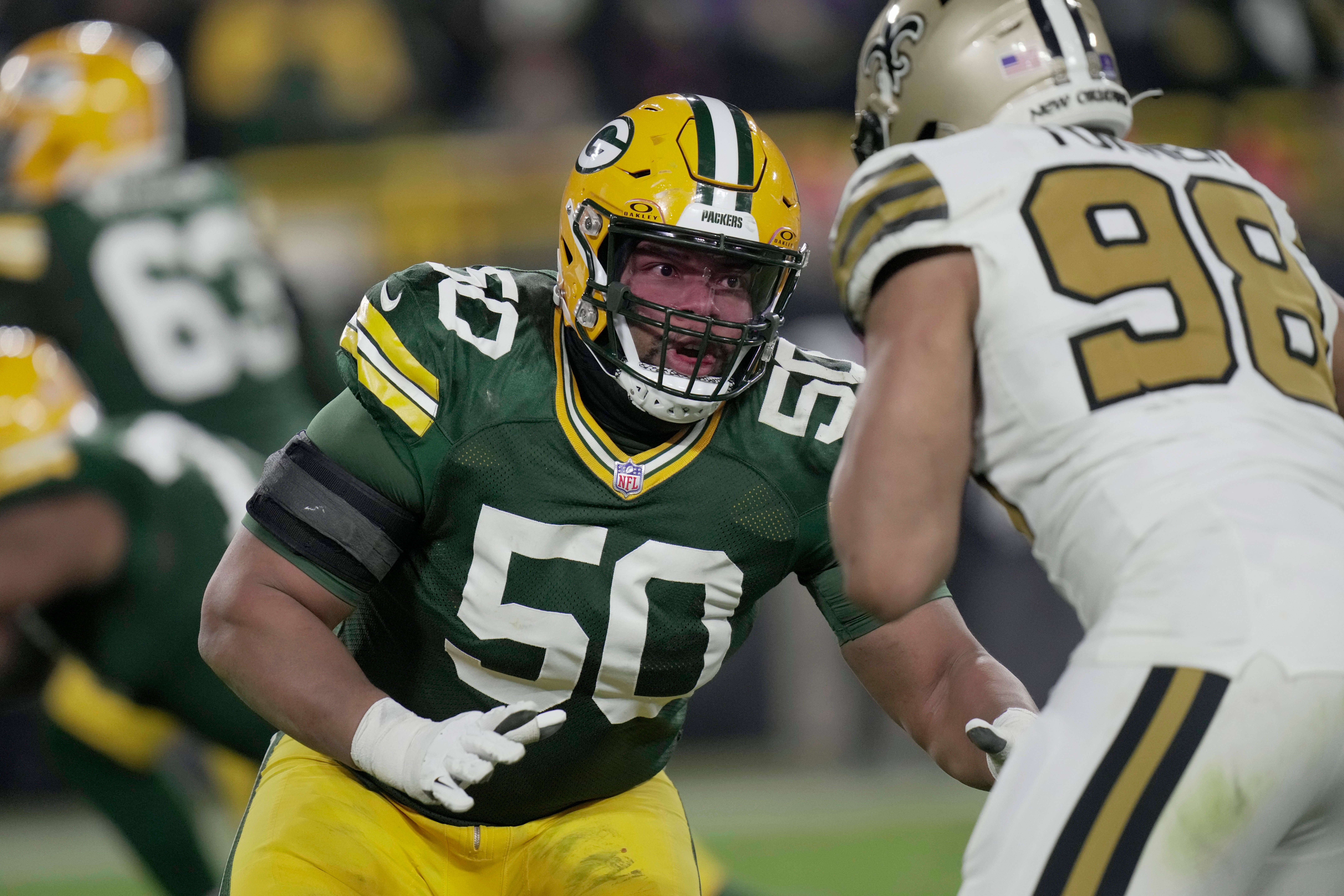 Green Bay Packers guard Zach Tom (50) blocks New Orleans Saints defensive end Payton Turner (98) during the third quarter at Lambeau Field.