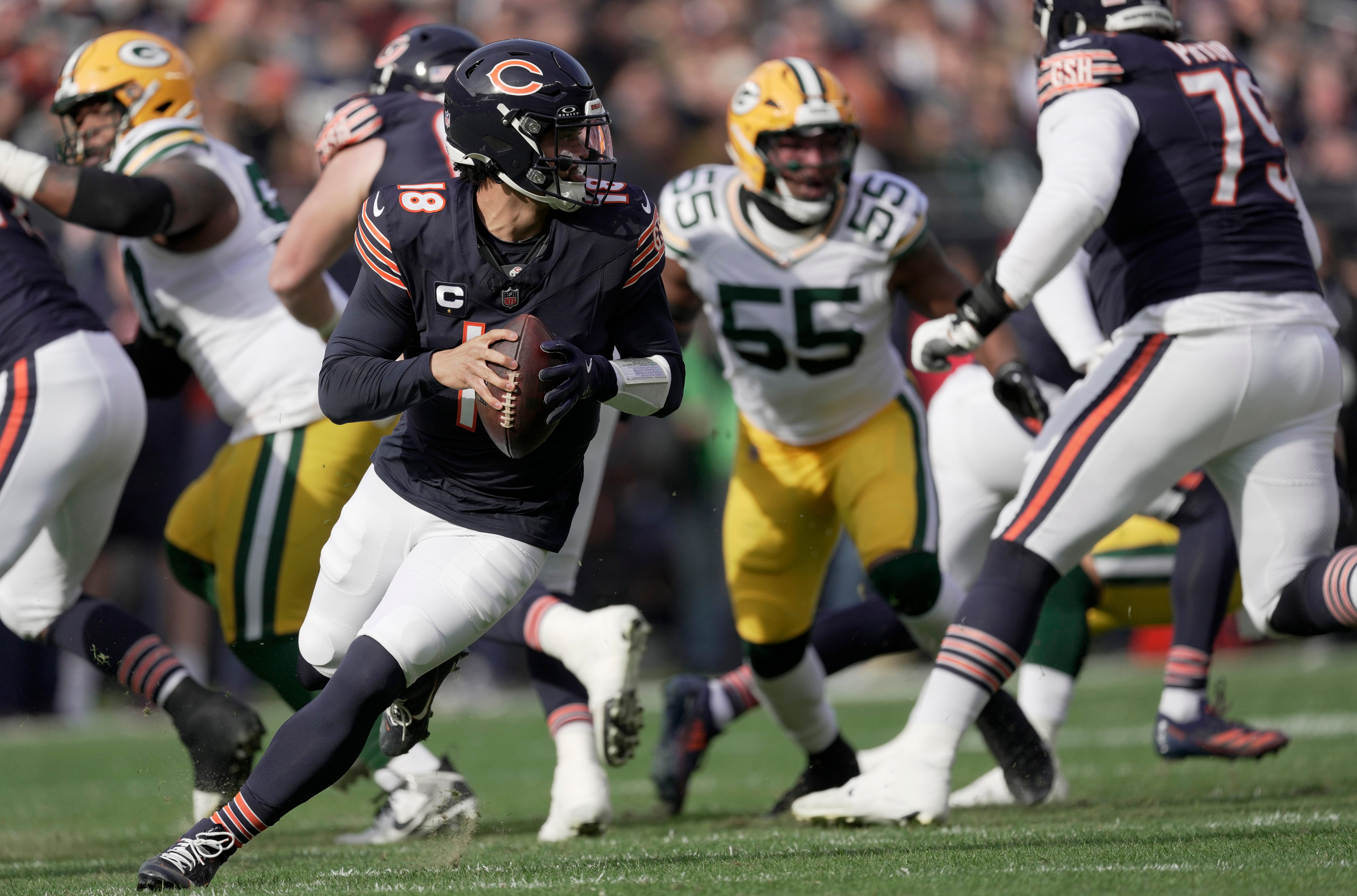 Chicago Bears quarterback Caleb Williams (18) rolls out during the first quarter of their game against the Green Bay Packers Sunday, November 17, 2024 at Soldier Field in Chicago, Illinois.