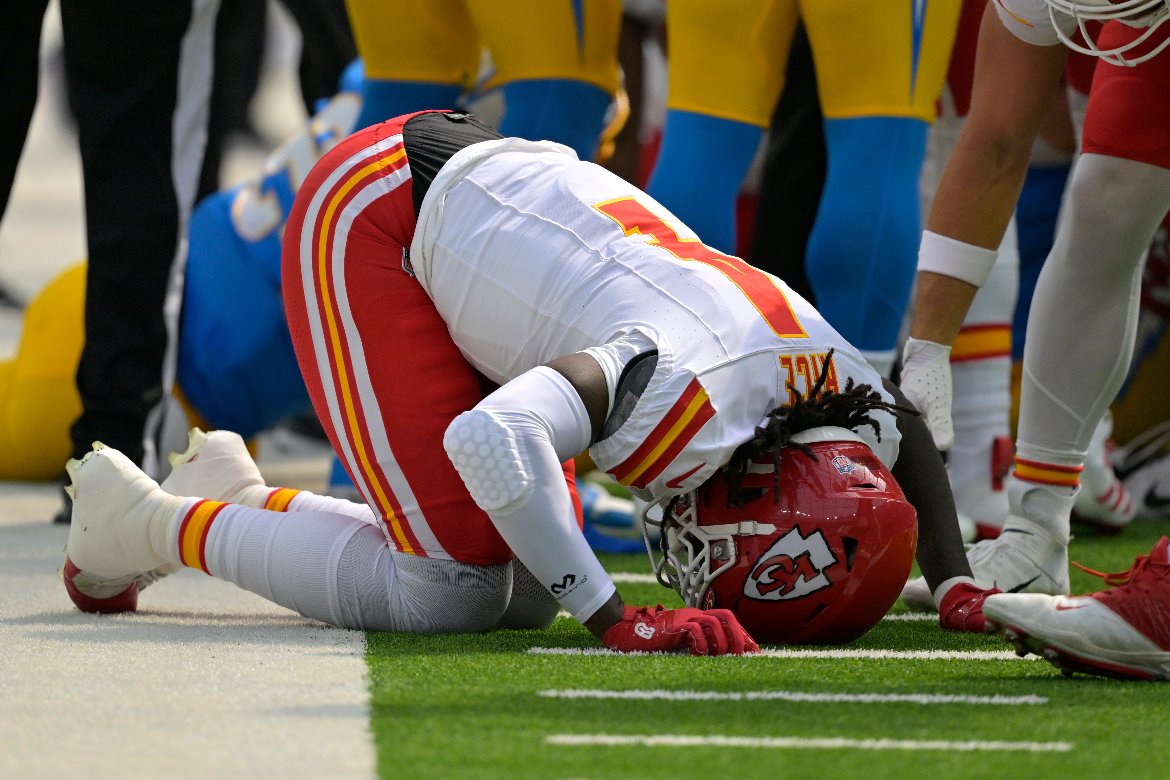 Sep 29, 2024; Inglewood, California, USA; Kansas City Chiefs wide receiver Rashee Rice (4) pounds his fist on the ground after an injury in the first half against the Los Angeles Chargers at SoFi Stadium.