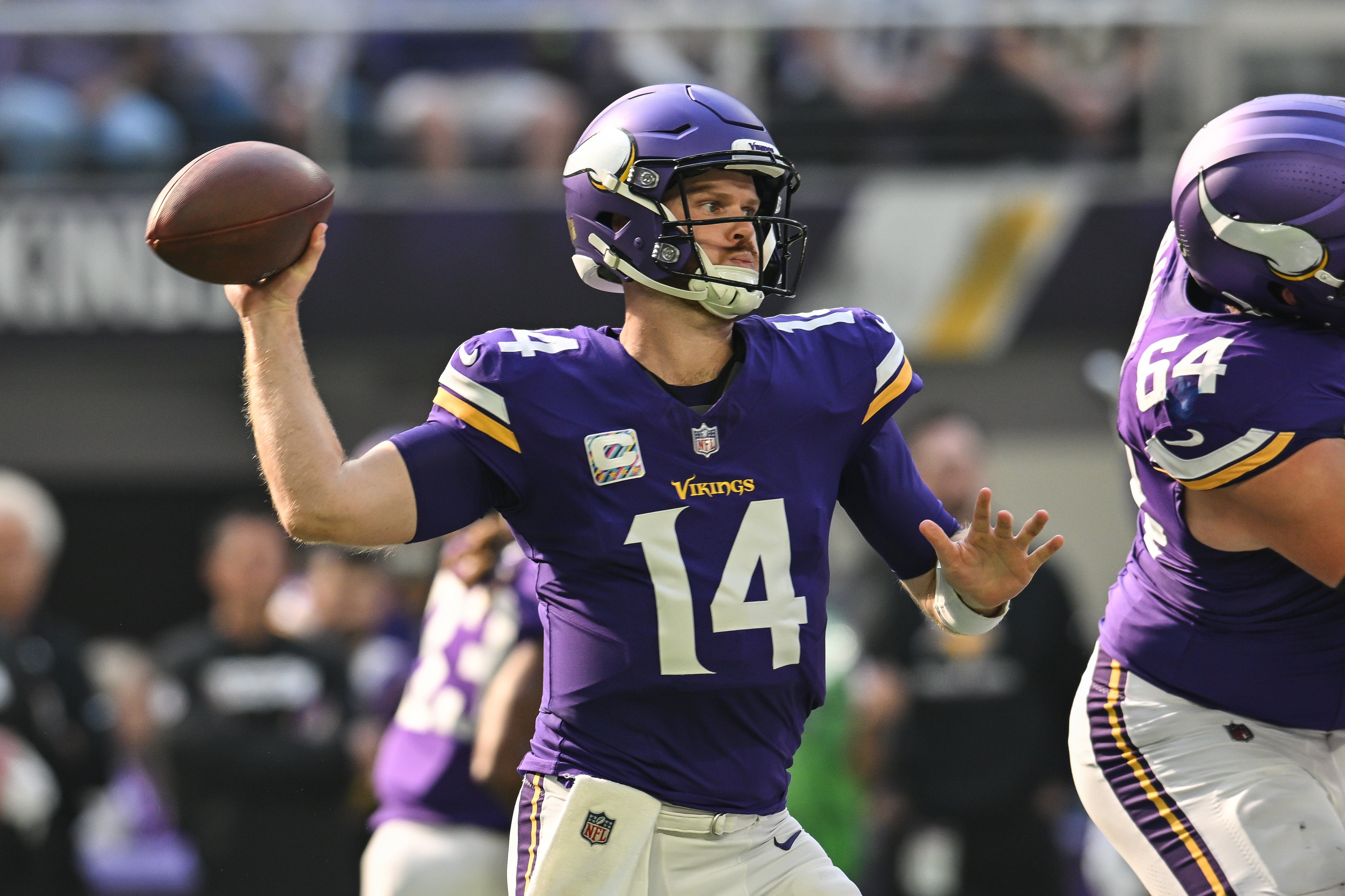 Oct 20, 2024; Minneapolis, Minnesota, USA; Minnesota Vikings quarterback Sam Darnold (14) throws a pass against the Detroit Lions during the first quarter at U.S. Bank Stadium.