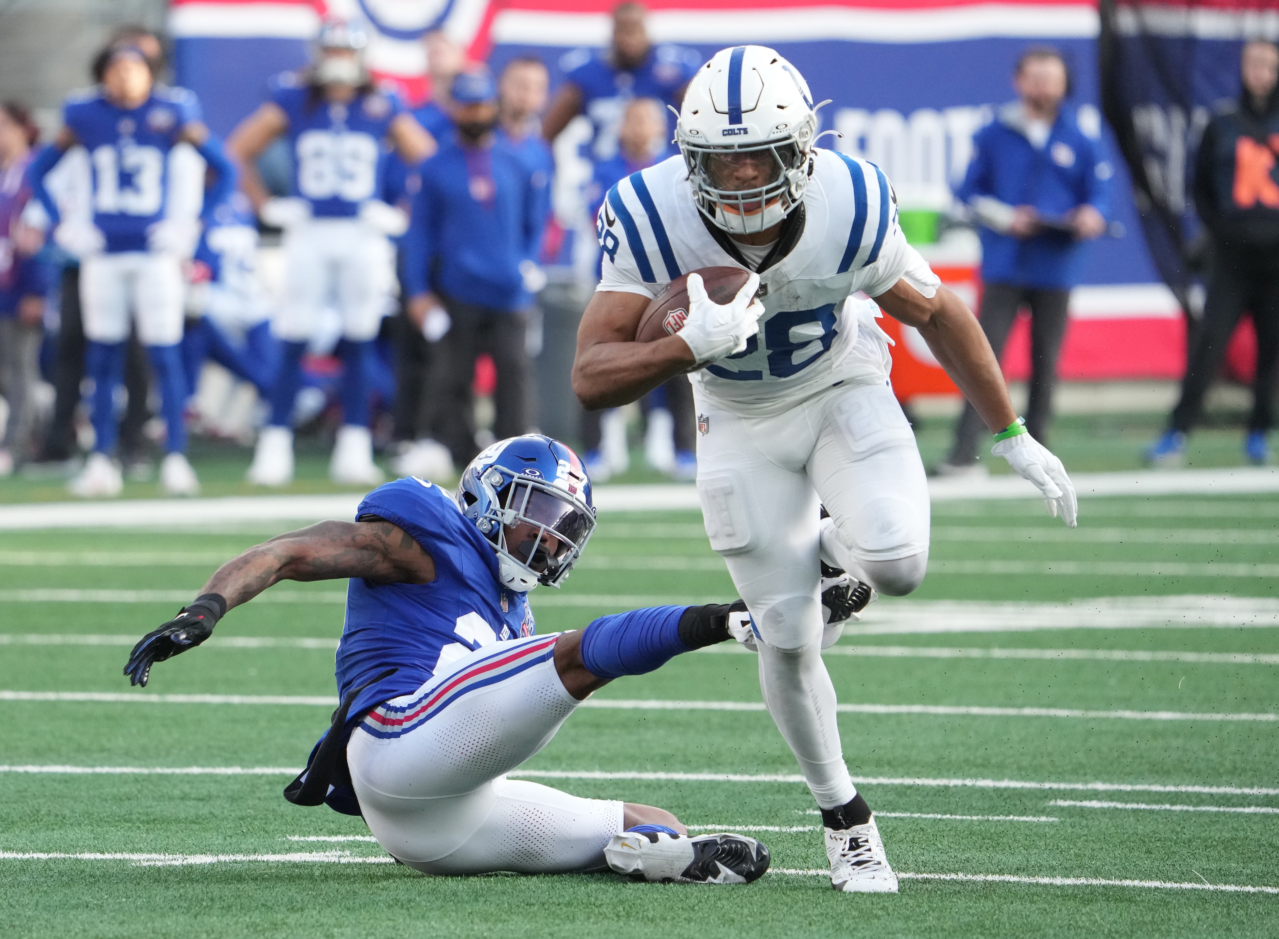 Dec 29, 2024; East Rutherford, New Jersey, USA; Indianapolis Colts running back Jonathan Taylor (28) runs past New York Giants safety Jason Pinnock (27) during the first half at MetLife Stadium.