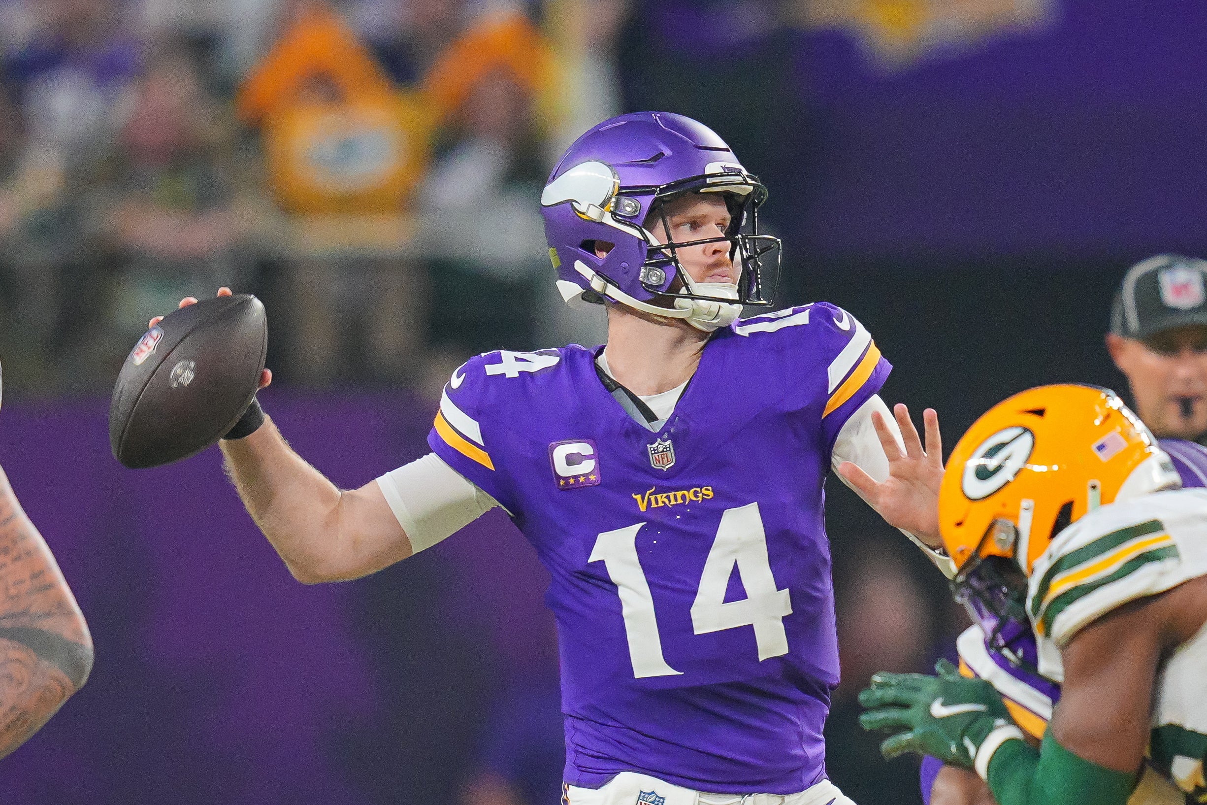 Dec 29, 2024; Minneapolis, Minnesota, USA; Minnesota Vikings quarterback Sam Darnold (14) passes against Green Bay Packers in the second quarter at U.S. Bank Stadium.