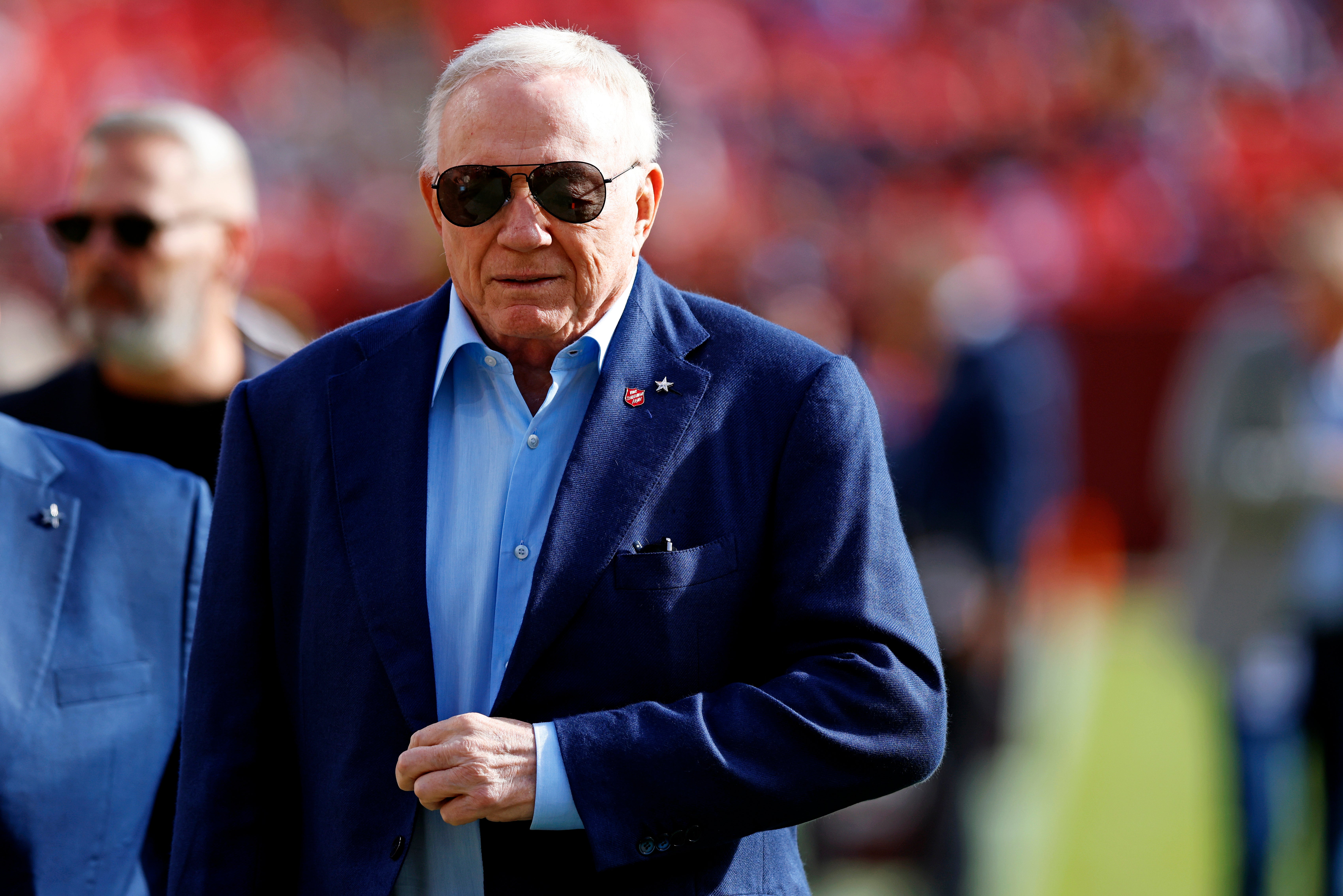 Dallas Cowboys owner Jerry Jones walks off the field before the game between the Washington Commanders and the Dallas Cowboys at Northwest Stadium.