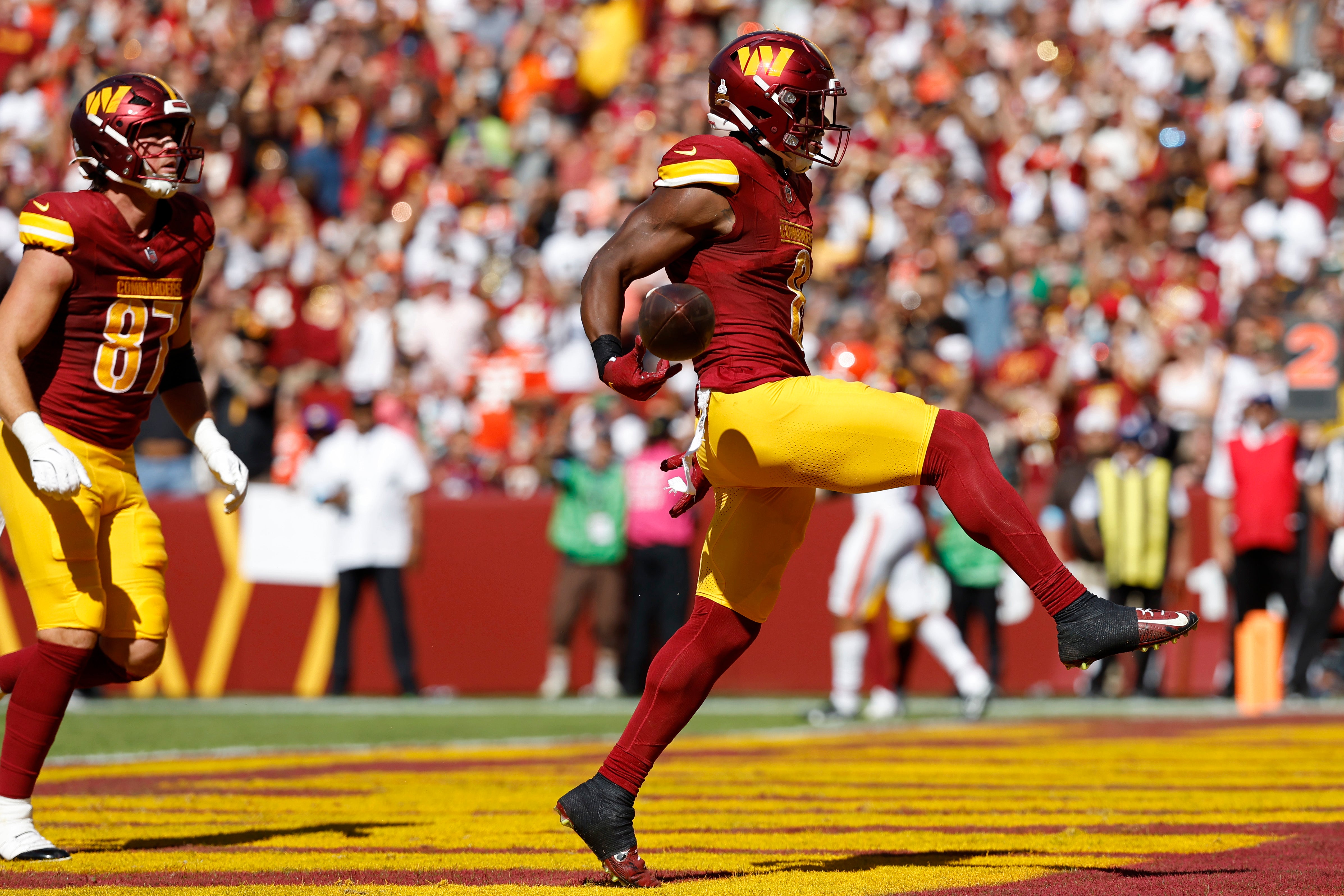 Oct 6, 2024; Landover, Maryland, USA; Washington Commanders running back Brian Robinson Jr. (8) celebrates after scoring a touchdown against the Cleveland Browns during the second quarter at NorthWest Stadium.