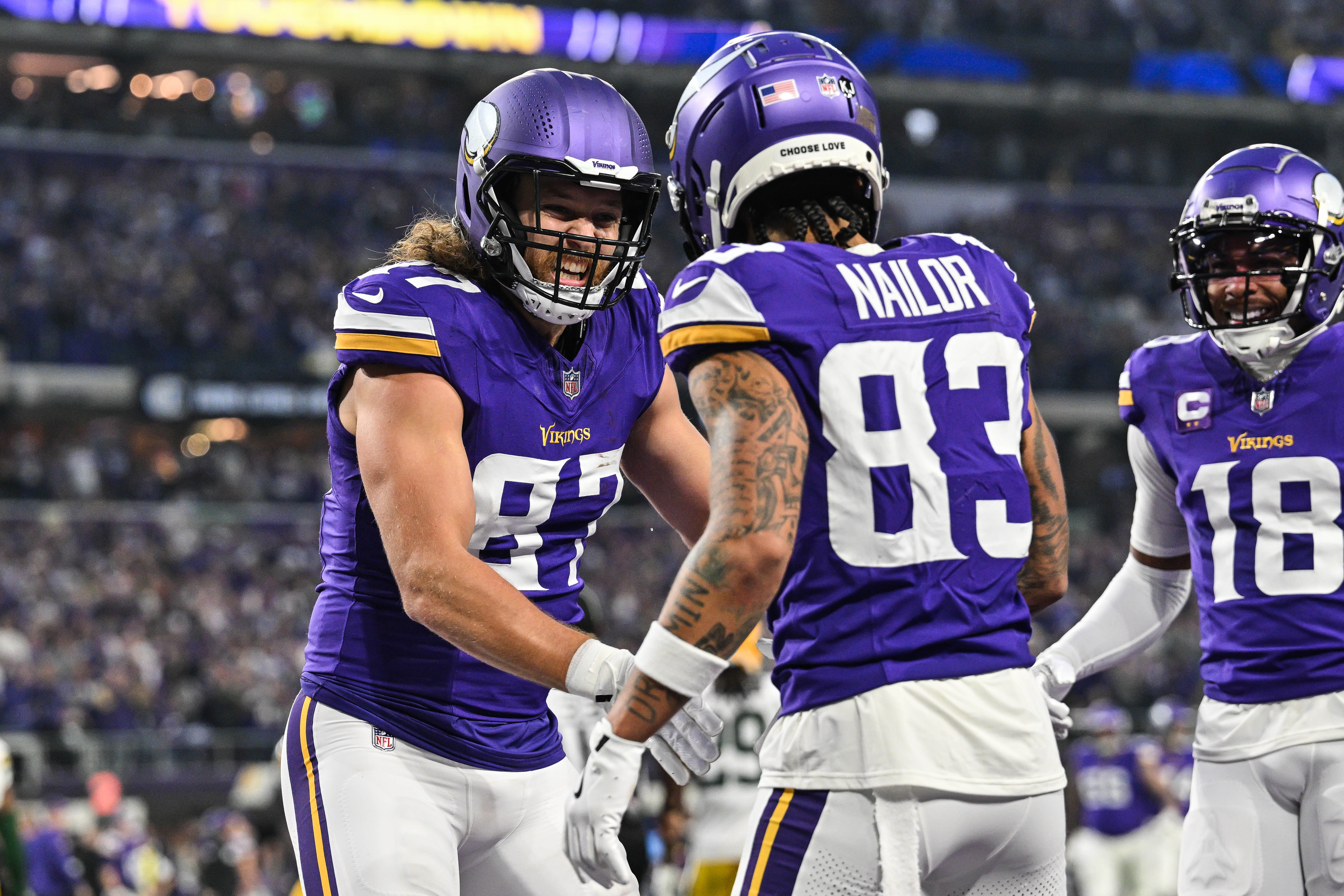 Dec 29, 2024; Minneapolis, Minnesota, USA; Minnesota Vikings tight end T.J. Hockenson (87) reacts with wide receiver Jalen Nailor (83) as wide receiver Justin Jefferson (18) looks on after Nailor scored a touchdown against the Green Bay Packers during the second quarter at U.S. Bank Stadium.