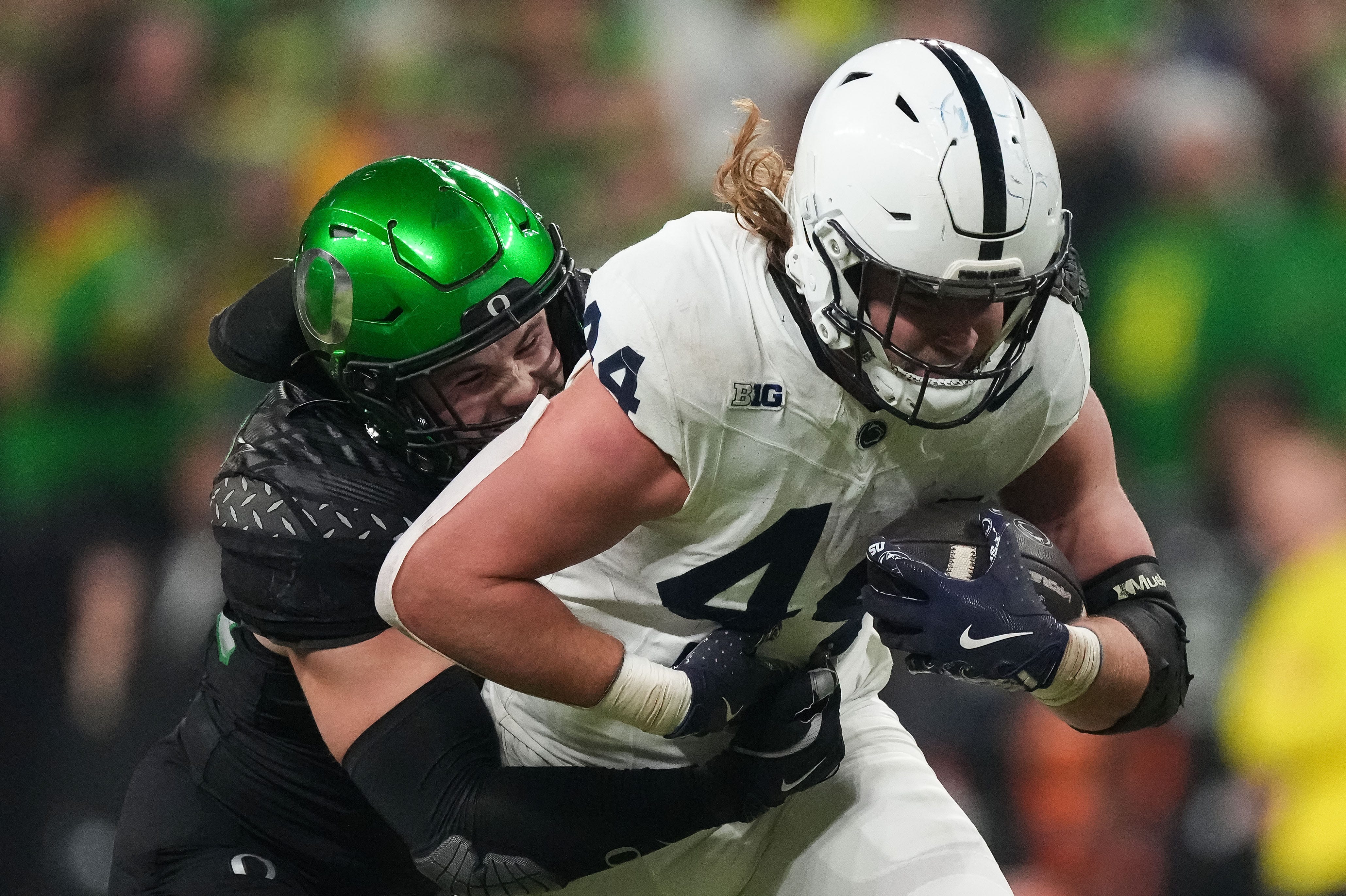 Penn State Nittany Lions tight end Tyler Warren (44) rushes up the field against Oregon Ducks linebacker Bryce Boettcher (28) on Saturday, Dec. 7, 2024, during the Big Ten Championship game at Lucas Oil Stadium in Indianapolis.