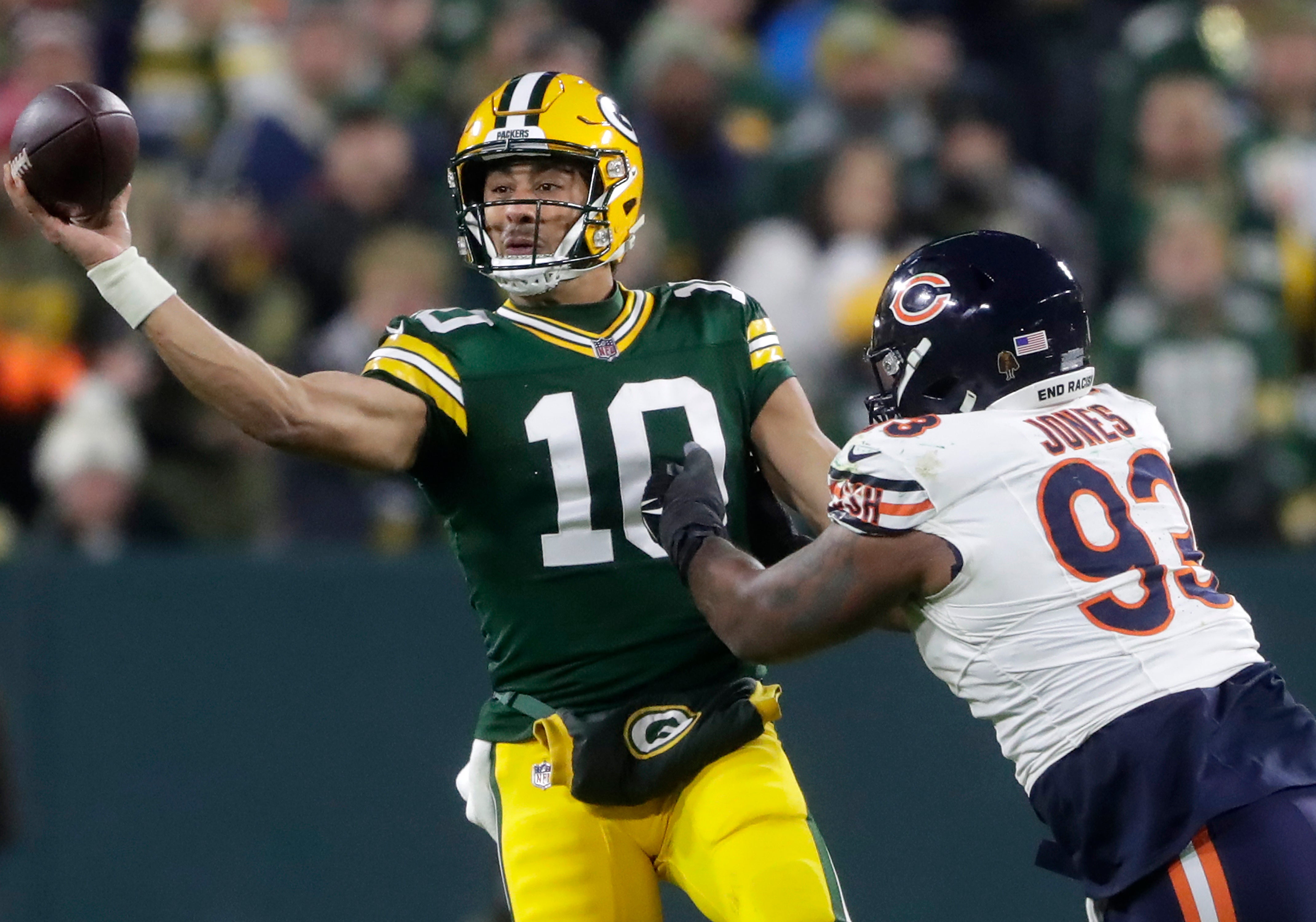 Green Bay Packers quarterback Jordan Love (10) throws under pressure from Chicago Bears defensive tackle Justin Jones (93) during their football game at Lambeau Field.