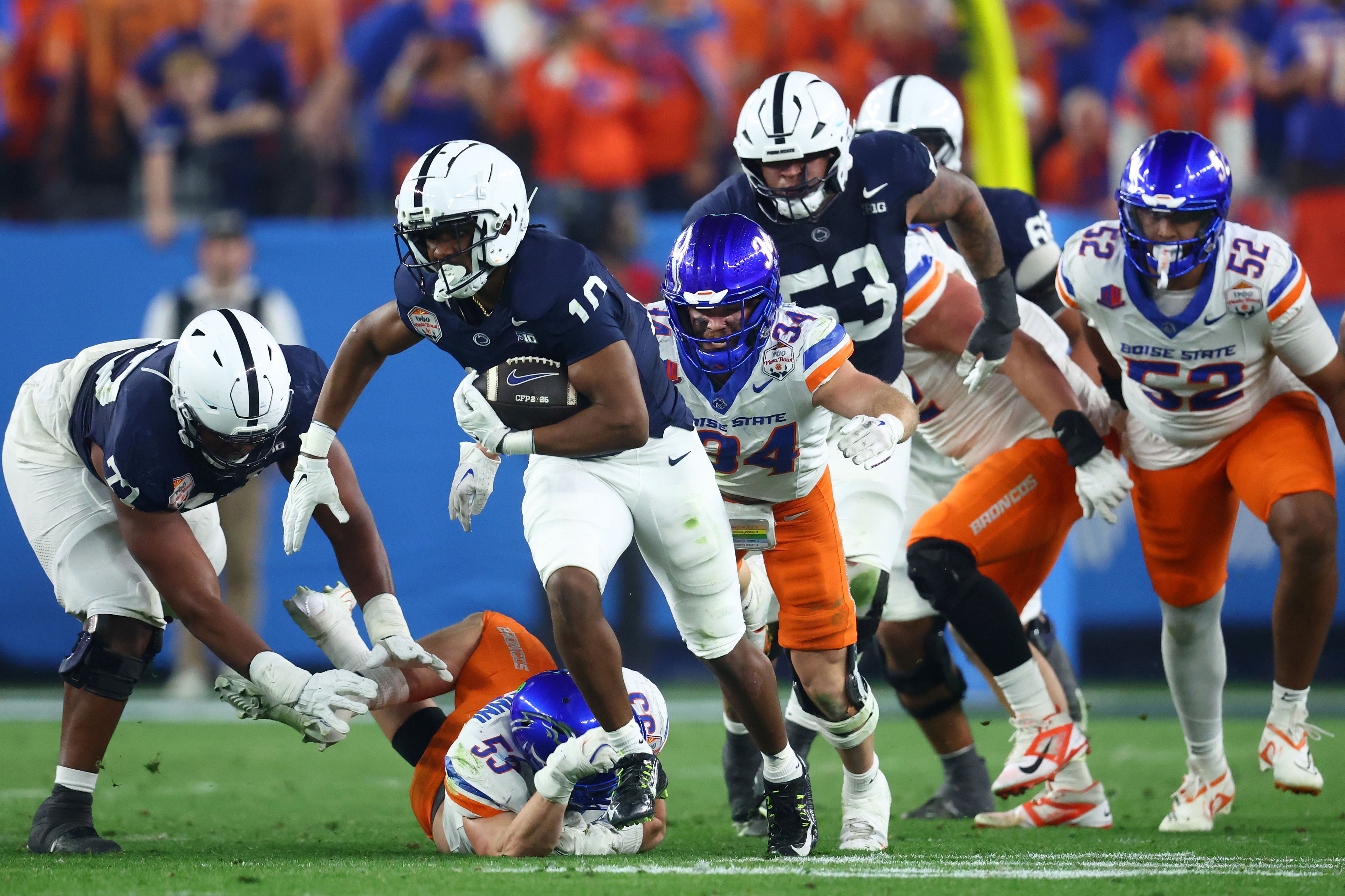 Penn State Nittany Lions running back Nicholas Singleton (10) rushes the ball against the Boise State Broncos during the first half in the Fiesta Bowl at State Farm Stadium.