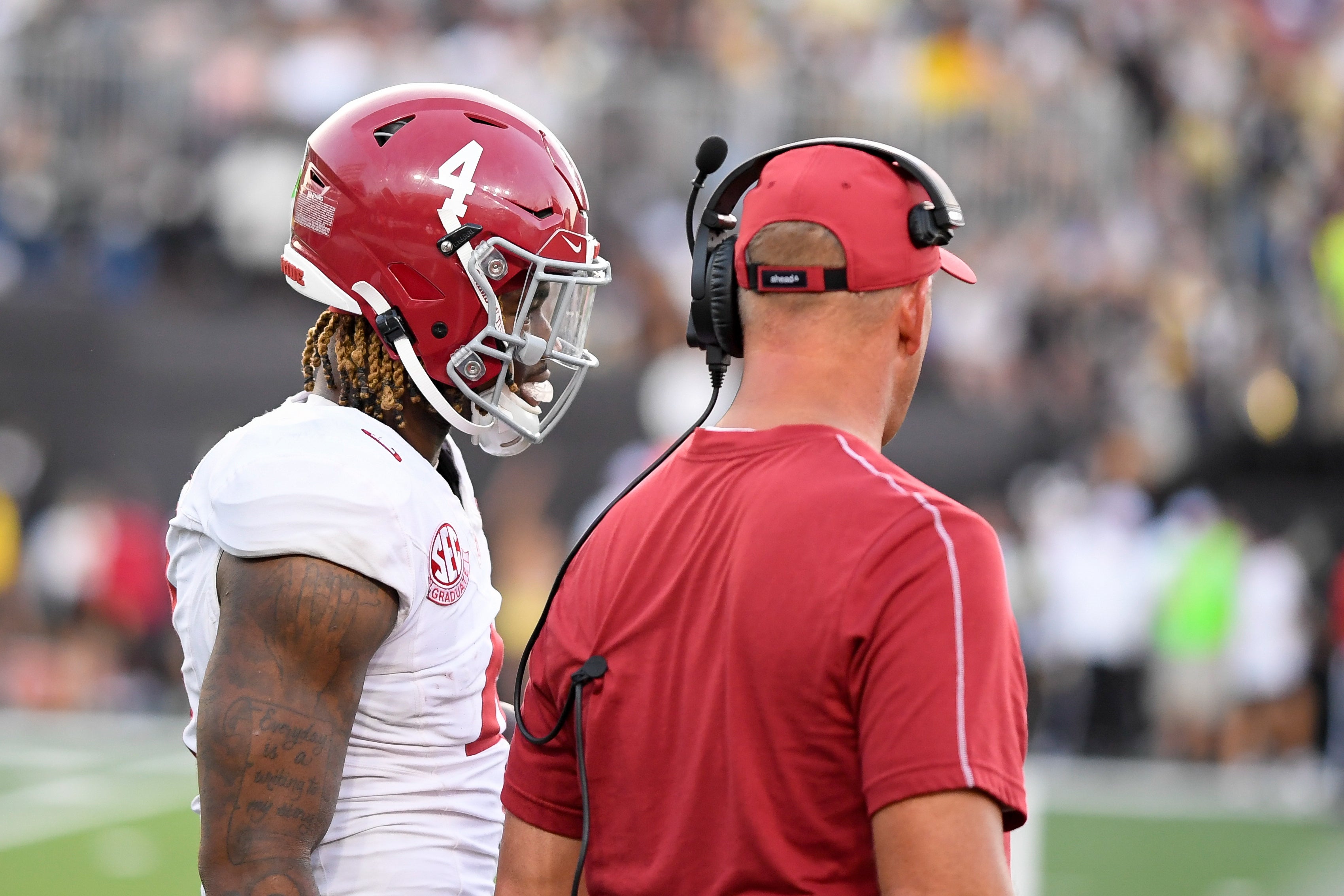 Oct 5, 2024; Nashville, Tennessee, USA; Alabama Crimson Tide head coach Kalen DeBoer talks with quarterback Jalen Milroe (4) against the Vanderbilt Commodores during the second half at FirstBank Stadium.