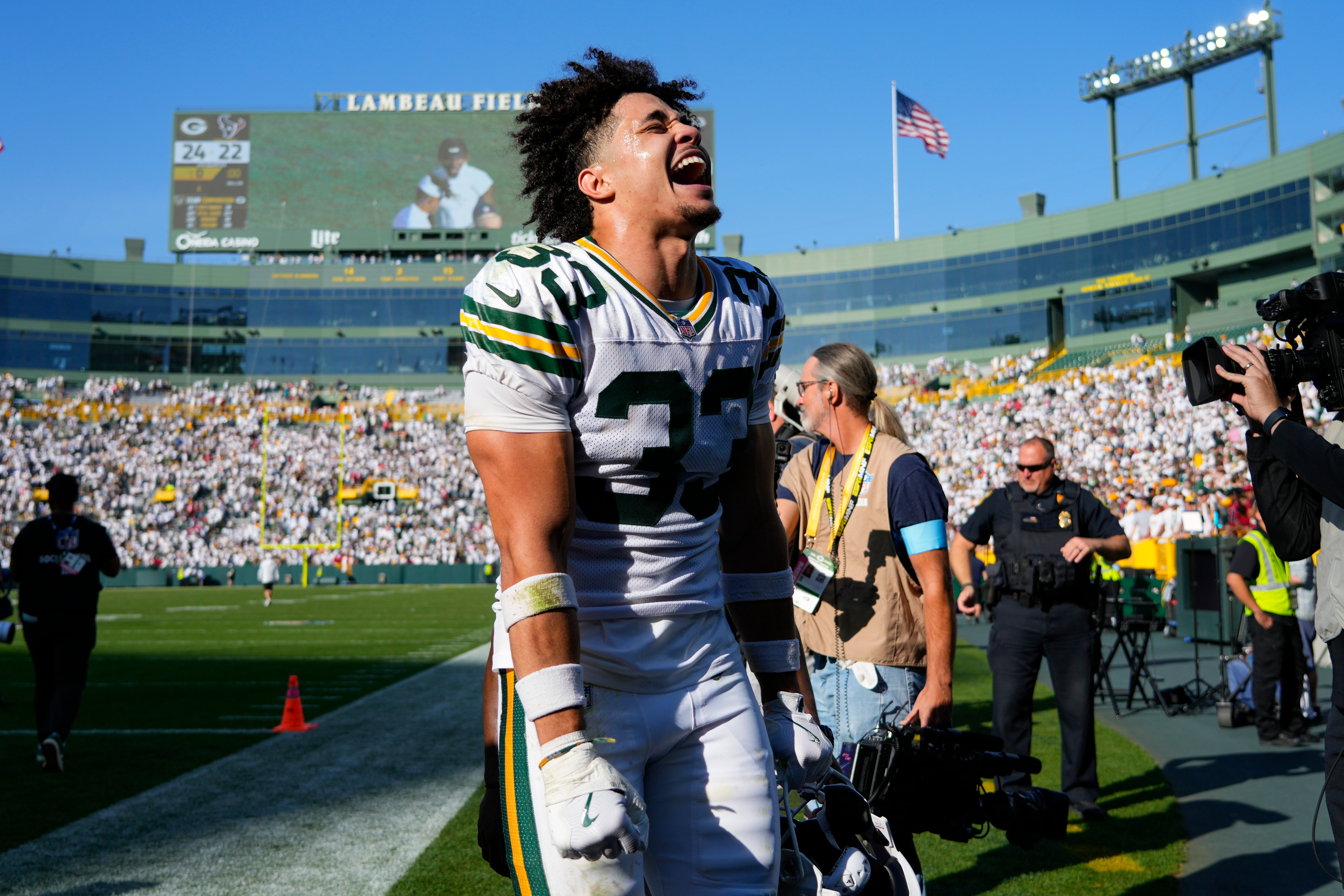 Green Bay Packers safety Evan Williams (33) celebrates as he runs off the field following the game against the Houston Texans at Lambeau Field.