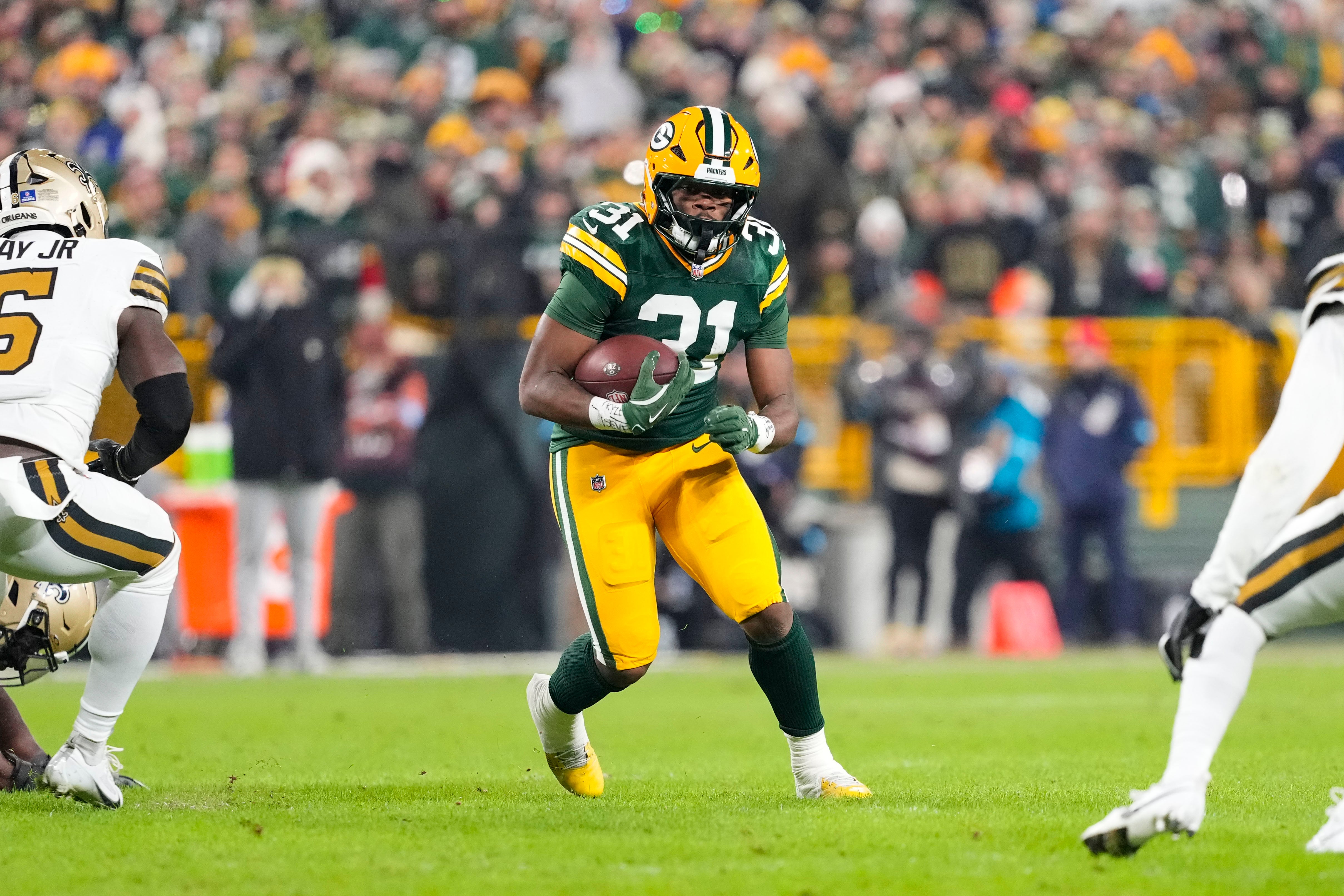 Green Bay Packers running back Emanuel Wilson (31) rushes with the football during the second quarter against the New Orleans Saints at Lambeau Field.