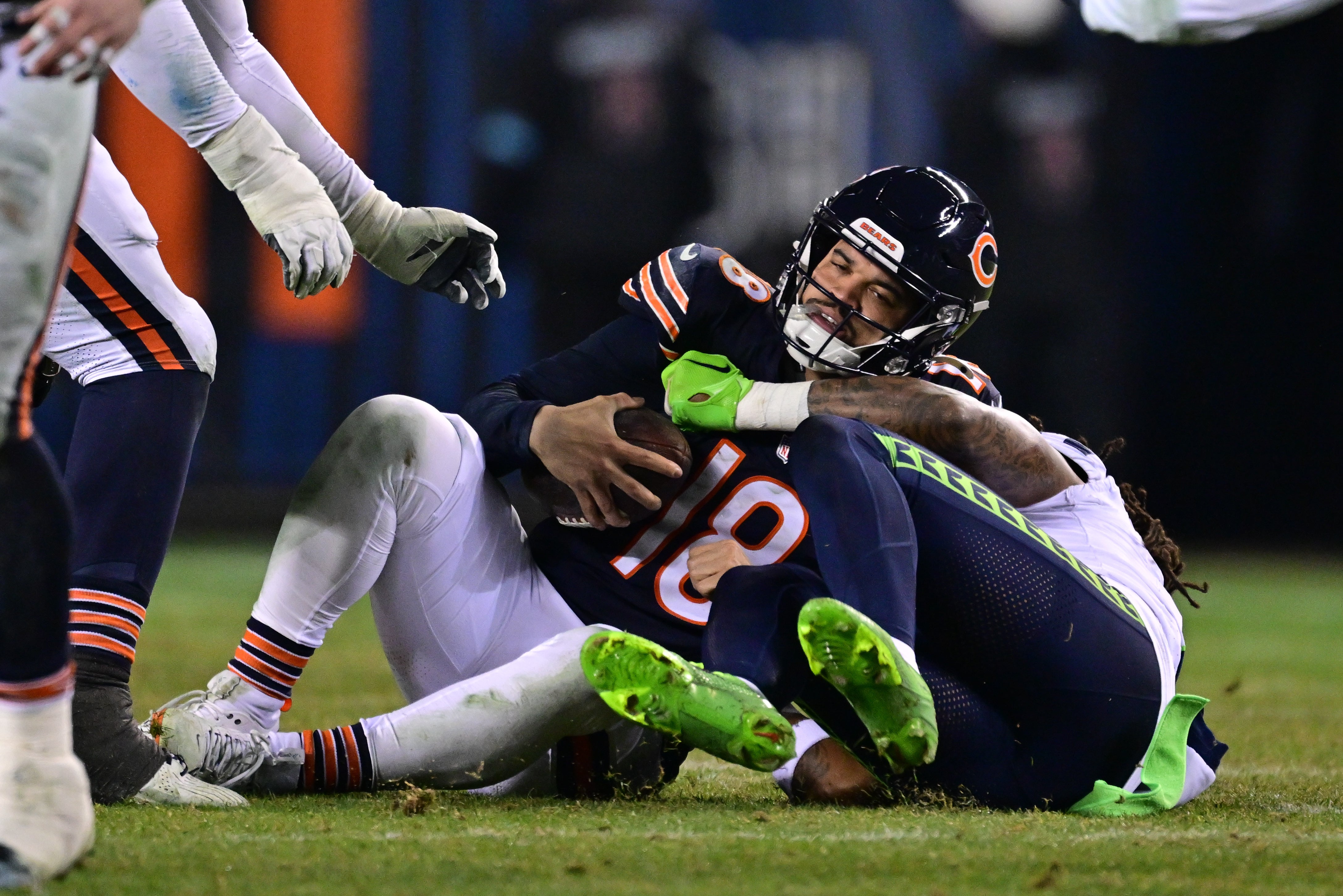 Dec 26, 2024; Chicago, Illinois, USA; Chicago Bears quarterback Caleb Williams (18) is sacked by Seattle Seahawks defensive back Rayshawn Jenkins (2) during the fourth quarter at Soldier Field.