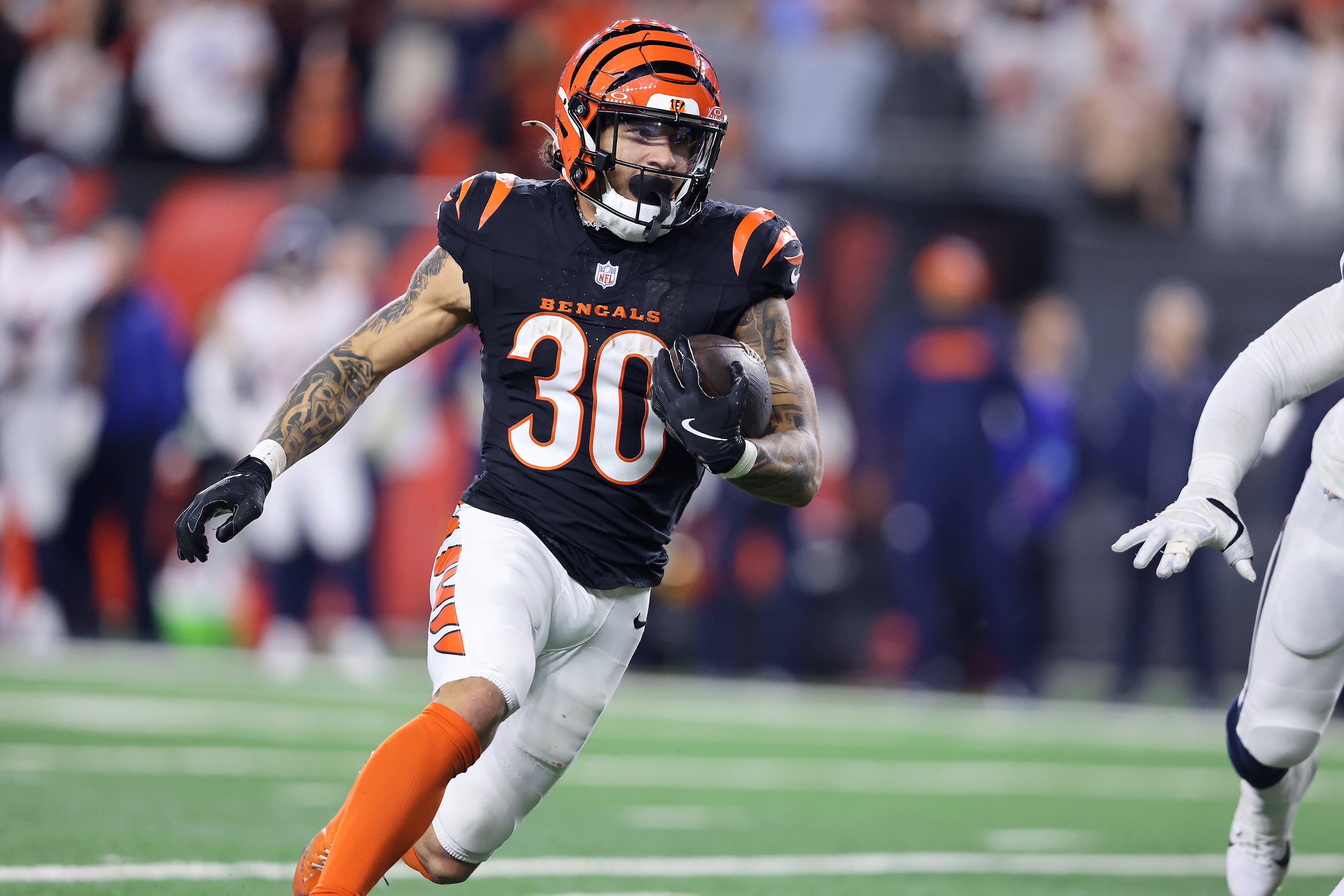 Dec 28, 2024; Cincinnati, Ohio, USA; Cincinnati Bengals running back Chase Brown (30) runs the ball during the fourth quarter against the Denver Broncos at Paycor Stadium.