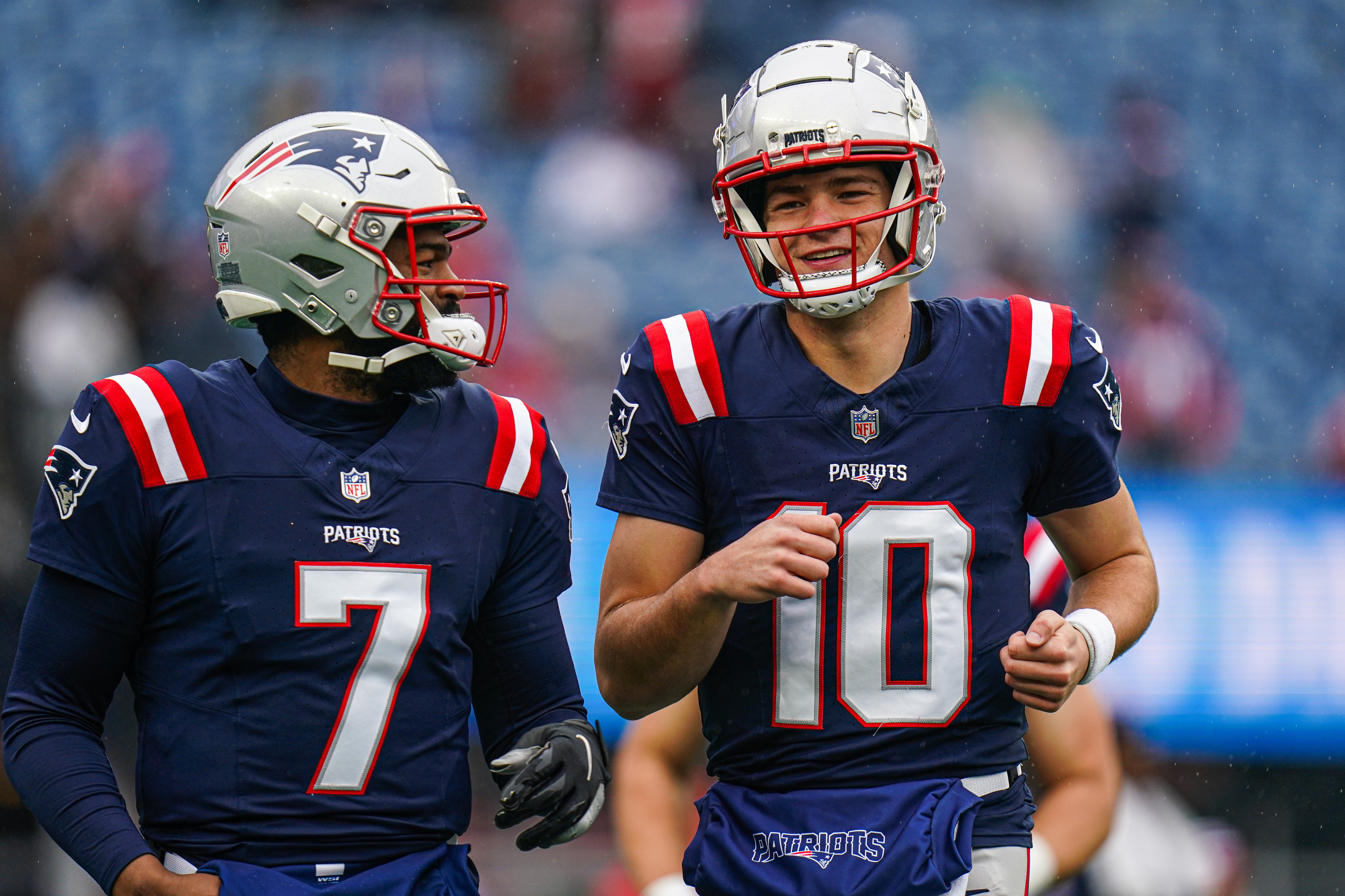 Dec 28, 2024; Foxborough, Massachusetts, USA; New England Patriots quarterback Drake Maye (10) and quarterback Jacoby Brissett (7) warm up before the start of the game against the Los Angeles Chargers at Gillette Stadium.