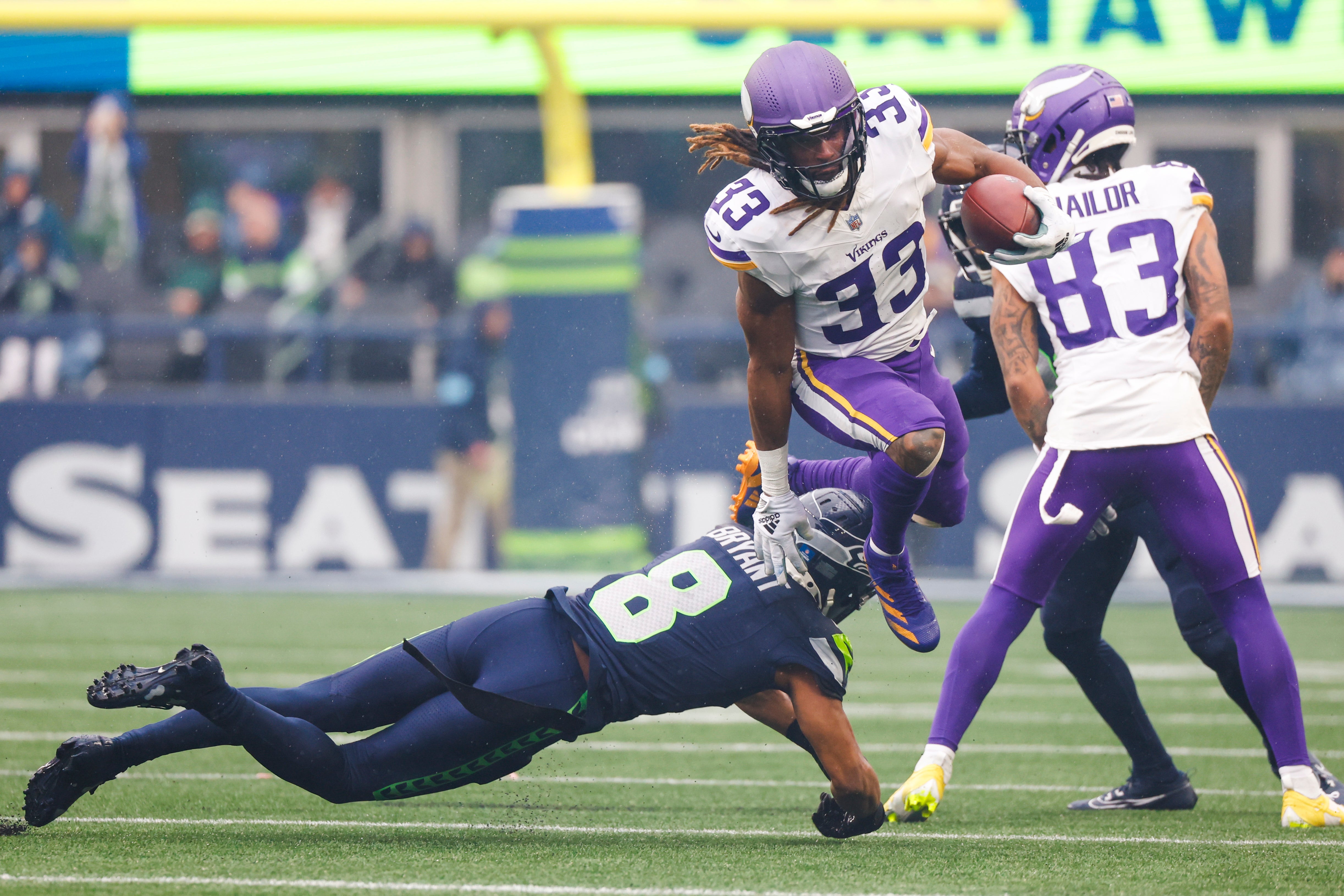 Dec 22, 2024; Seattle, Washington, USA; Minnesota Vikings running back Aaron Jones (33) rushes against the Seattle Seahawks during the first quarter at Lumen Field.