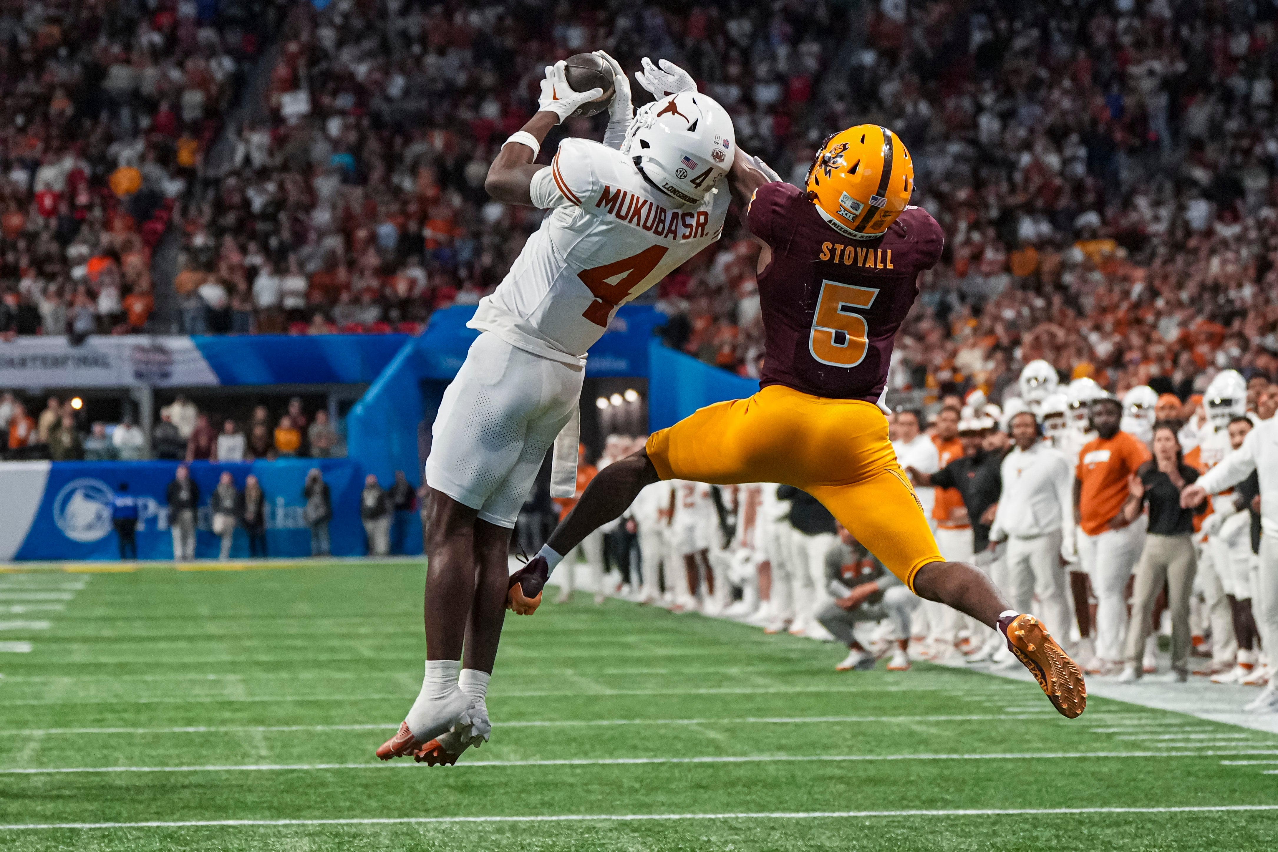 Jan 1, 2025; Atlanta, GA, USA; Texas Longhorns defensive back Andrew Mukuba (4) intercepts a pass in front of Arizona State Sun Devils wide receiver Melquan Stovall (5) to end the game in the second overtime at Mercedes-Benz Stadium.