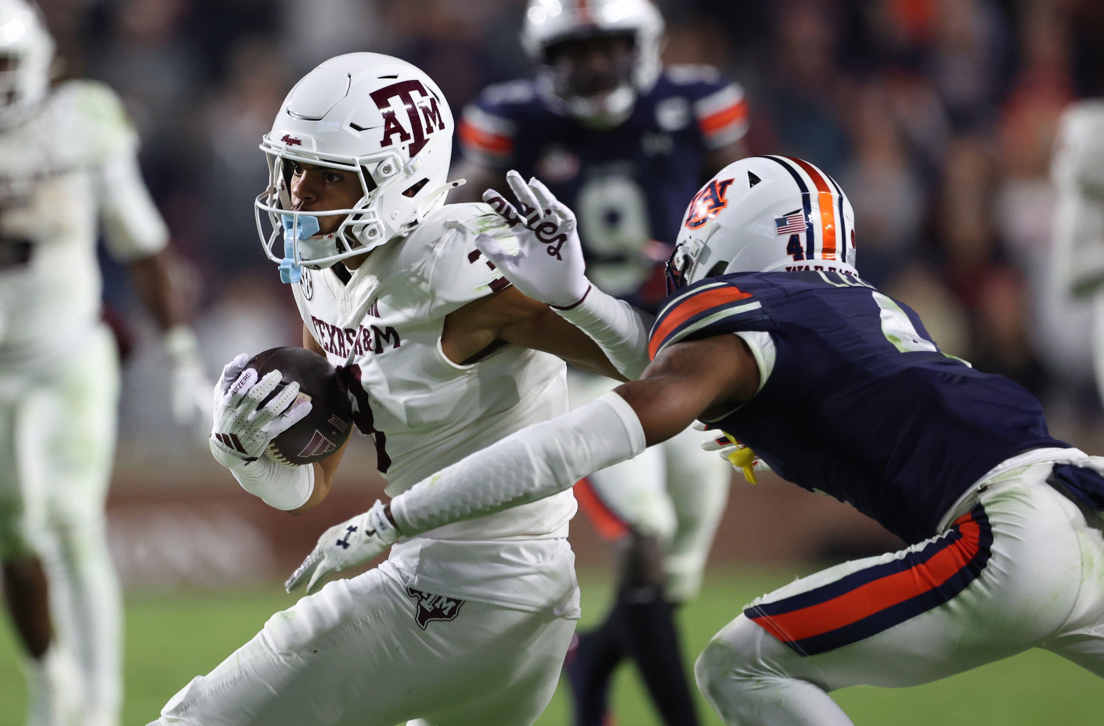 Auburn Tigers cornerback Kayin Lee (4) closes in on Texas A&M Aggies wide receiver Noah Thomas (3) during the second overtime at Jordan-Hare Stadium.