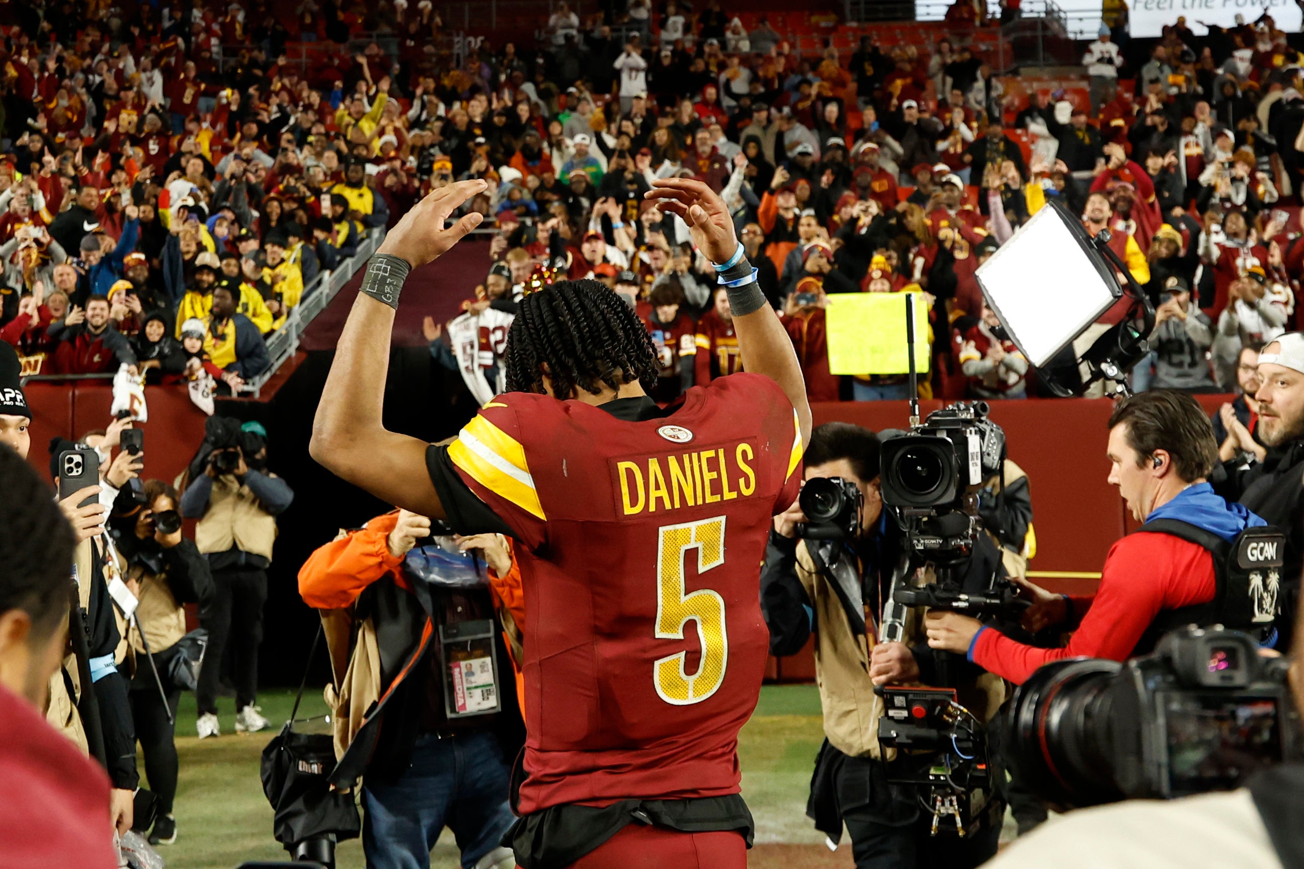 Dec 29, 2024; Landover, Maryland, USA; Washington Commanders quarterback Jayden Daniels (5) celebrates while leaving the field after the Commanders' game against the Atlanta Falcons at Northwest Stadium.