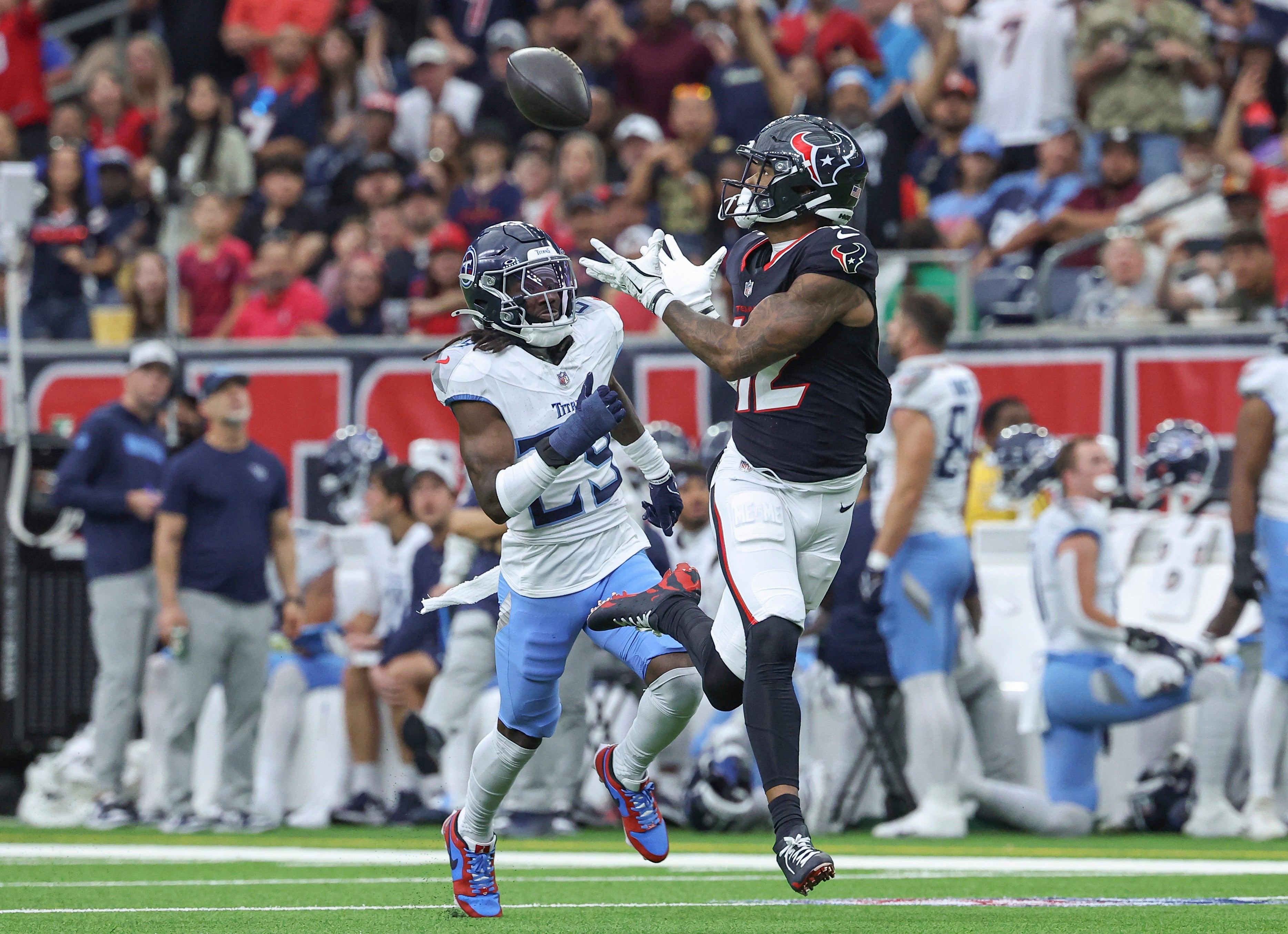 Nov 24, 2024; Houston, Texas, USA; Houston Texans wide receiver Nico Collins (12) makes a reception as Tennessee Titans cornerback Jarvis Brownlee Jr. (29) defends during the second quarter at NRG Stadium.