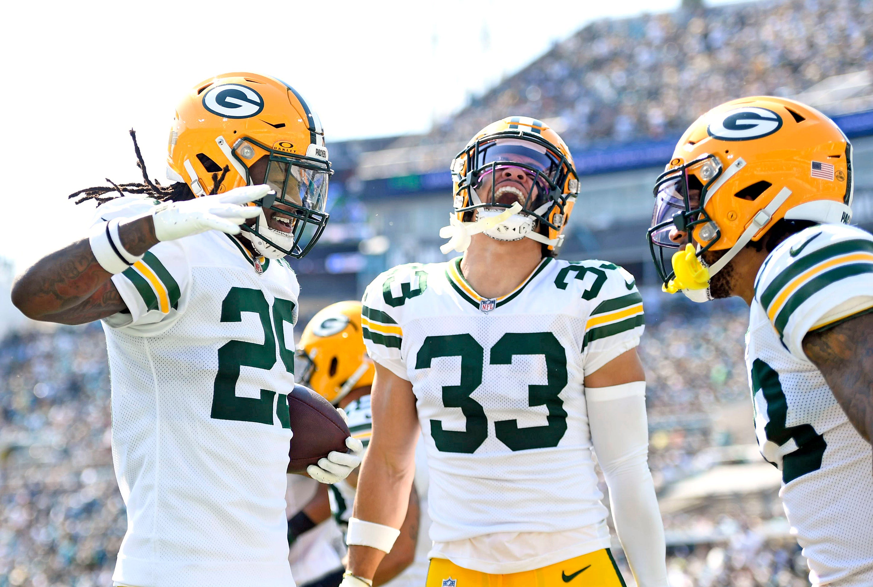 Green Bay Packers safety Xavier McKinney (29) celebrates an interception with safety Evan Williams (33) during the first half against the Jacksonville Jaguars at EverBank Stadium.