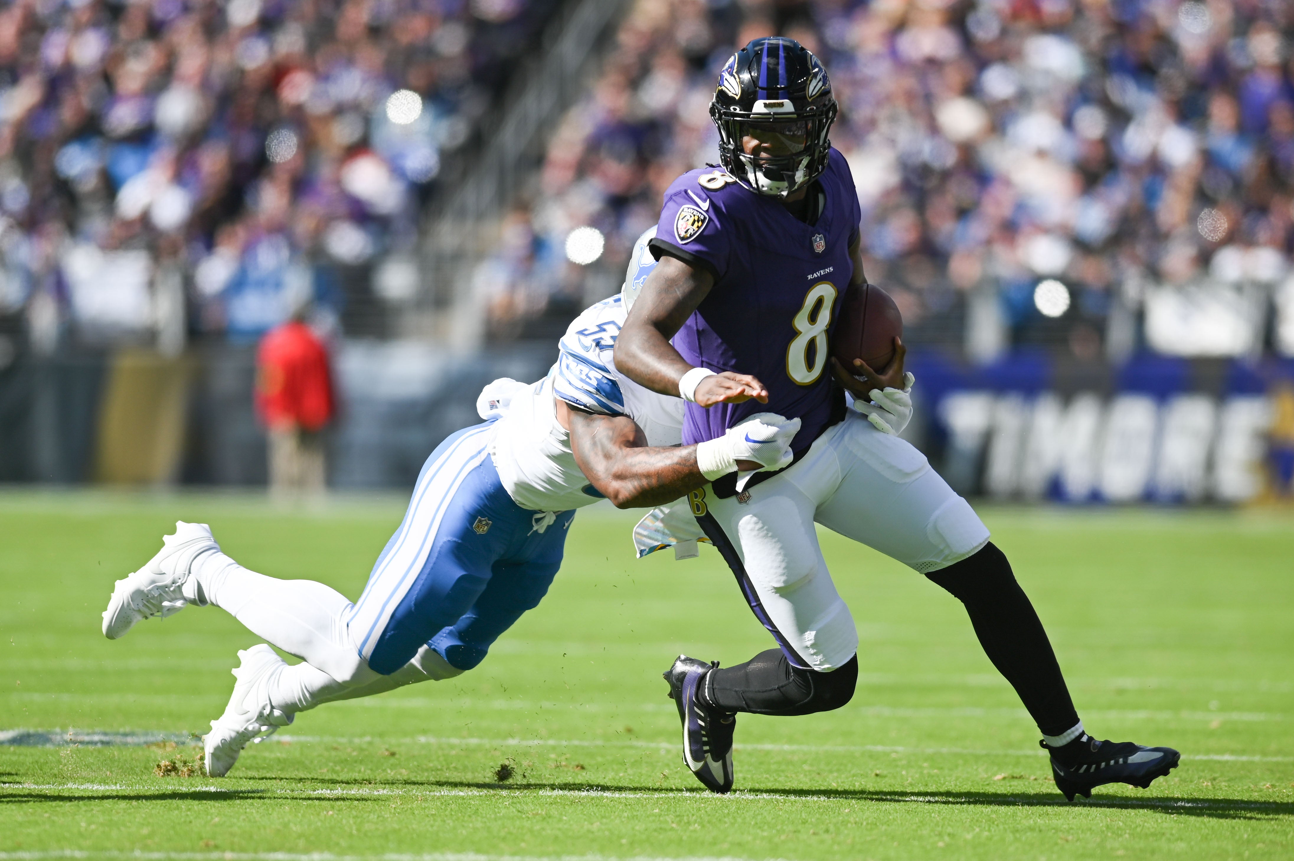 Ravens quarterback Lamar Jackson (8) runs of a first half first down against the Lions.