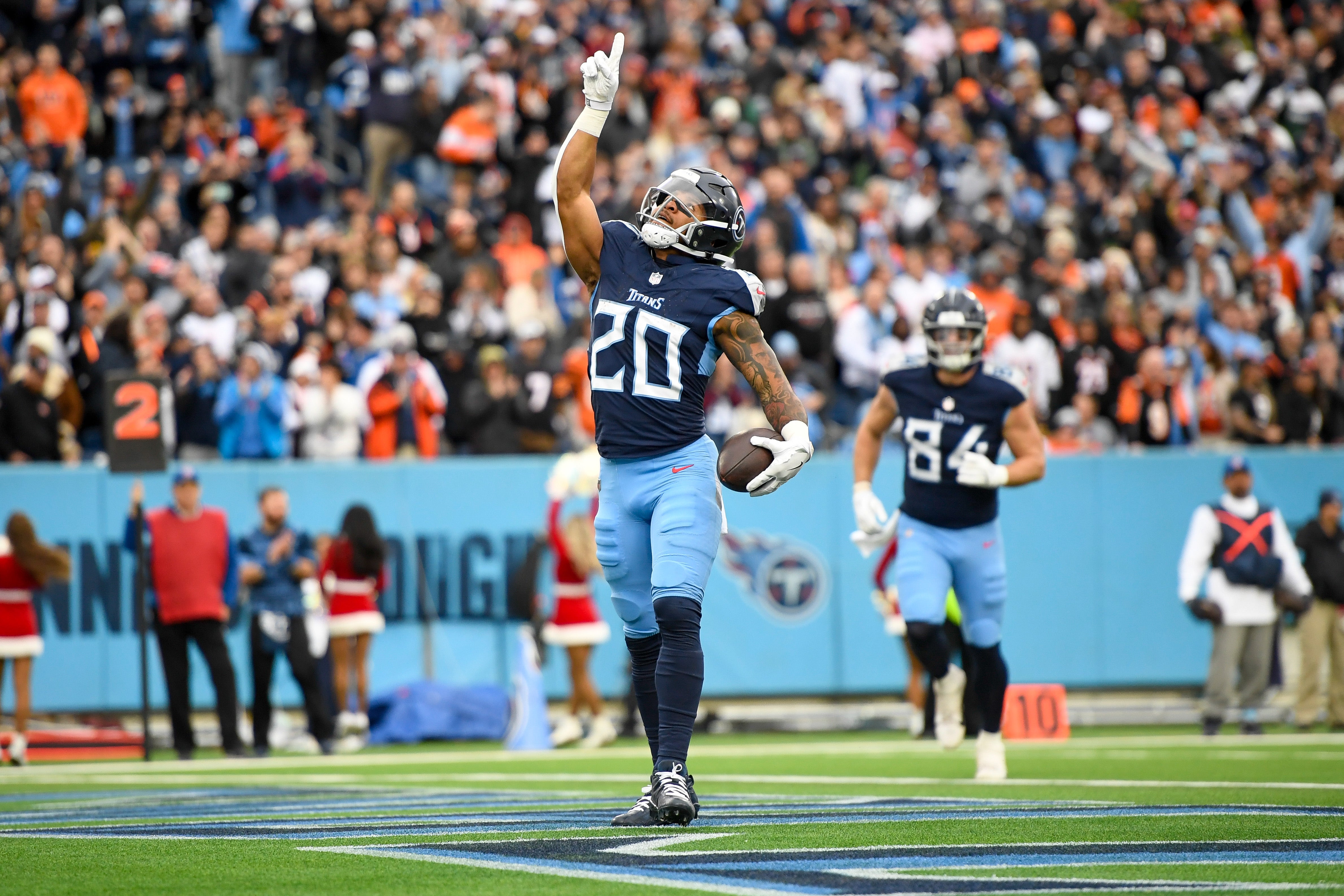 Dec 15, 2024; Nashville, Tennessee, USA; Tennessee Titans running back Tony Pollard (20) celebrates his touchdown against the Cincinnati Bengals during the first half at Nissan Stadium. Mandatory Credit: Steve Roberts-Imagn Images