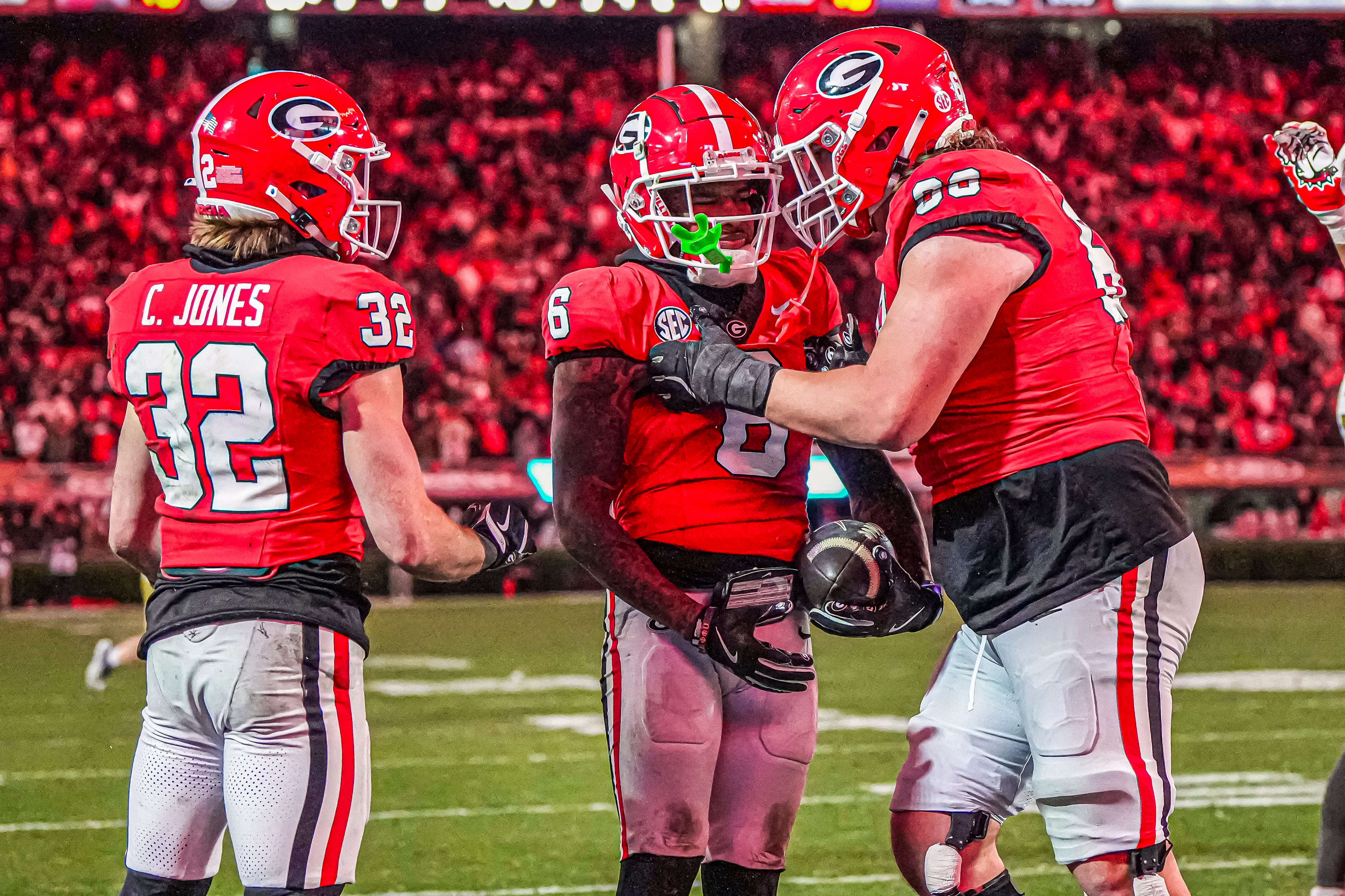 Nov 29, 2024; Athens, Georgia, USA; Georgia Bulldogs wide receiver Dominic Lovett (6) reacts with running back Cash Jones (32) and offensive lineman Tate Ratledge (69) after catching a touchdown pass against the Georgia Tech Yellow Jackets during the second half at Sanford Stadium.