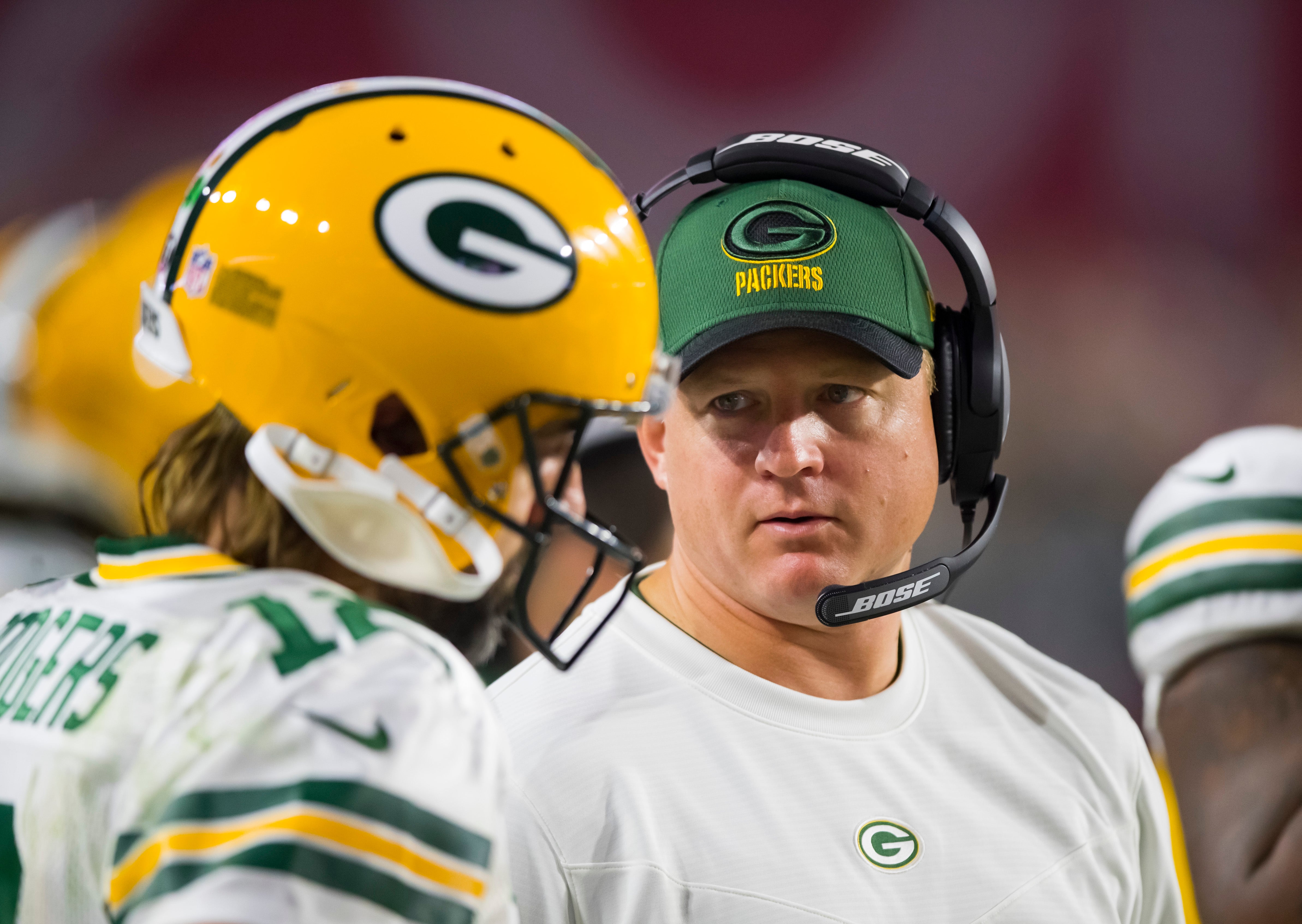 Green Bay Packers quarterbacks coach Luke Getsy talks to Aaron Rodgers (12) against the Arizona Cardinals at State Farm Stadium.