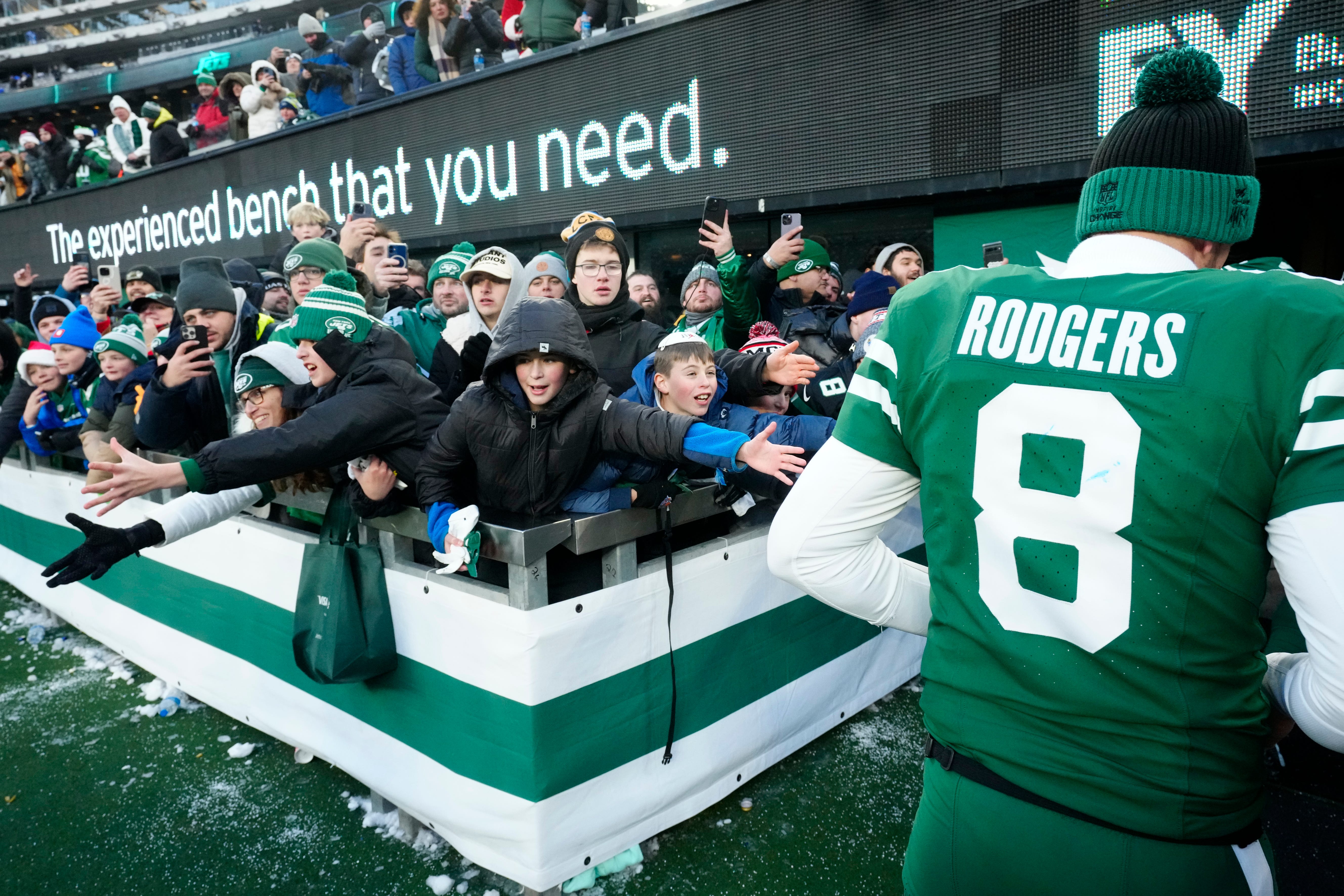 Young fans try to get the attention of New York Jets quarterback Aaron Rodgers (8) after the game, Sunday, December 22, 2024, in East Rutherford.