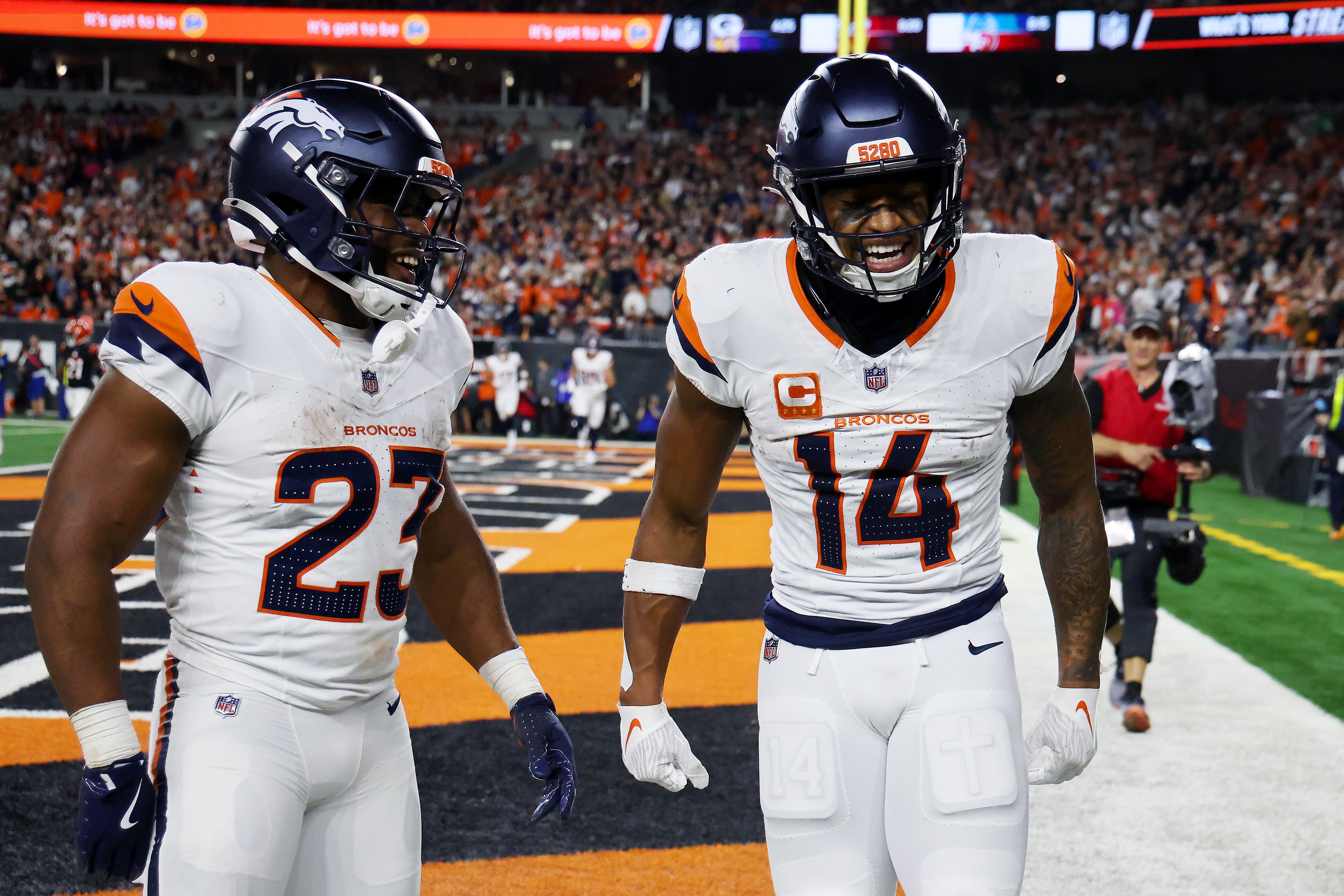 Broncos WR Courtland Sutton (14) celebrates his touchdown with Broncos running back Audric Estime (23) during the third quarter against the Bengals.