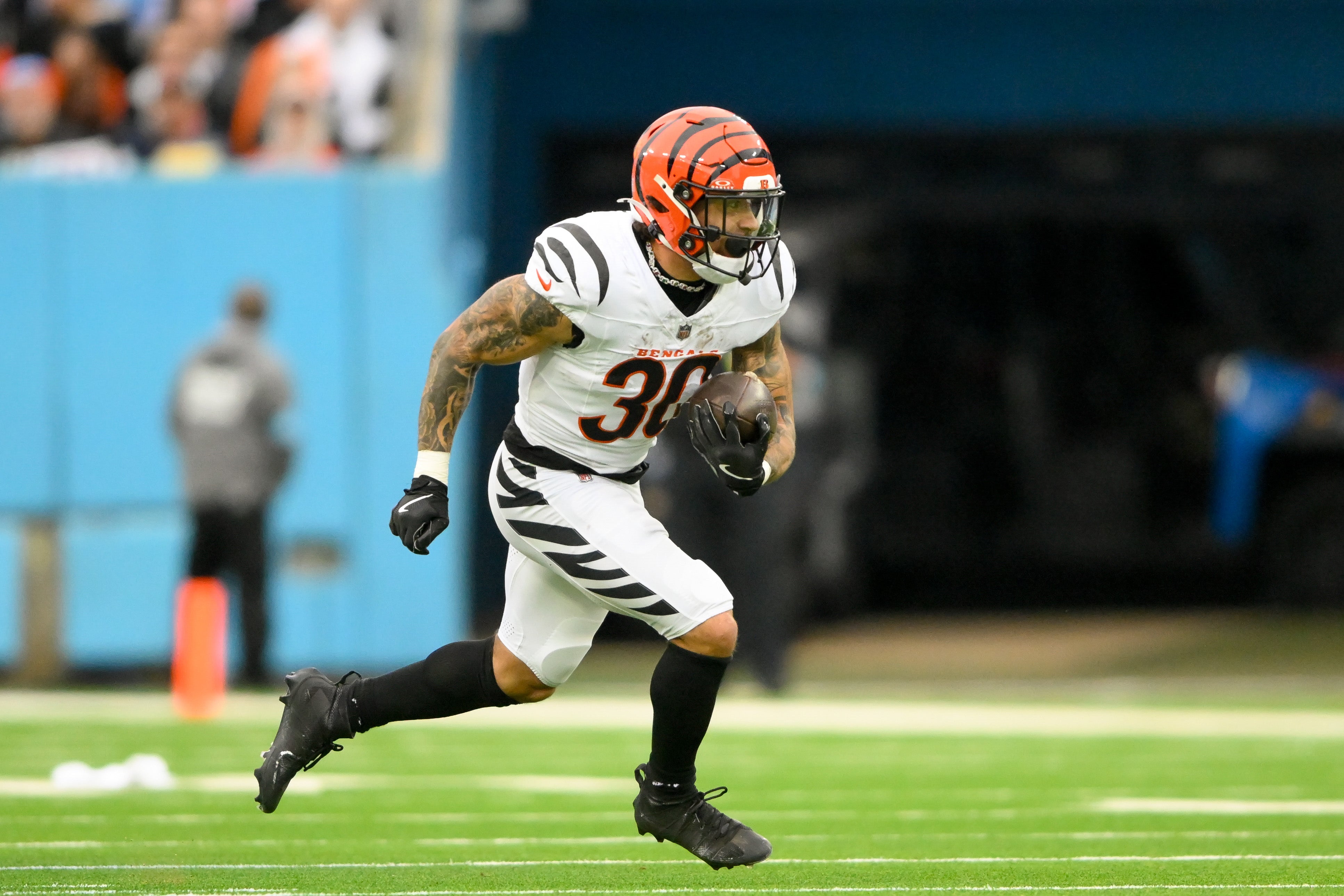 Dec 15, 2024; Nashville, Tennessee, USA; Cincinnati Bengals running back Chase Brown (30) runs the ball against the Tennessee Titans during the first half at Nissan Stadium.