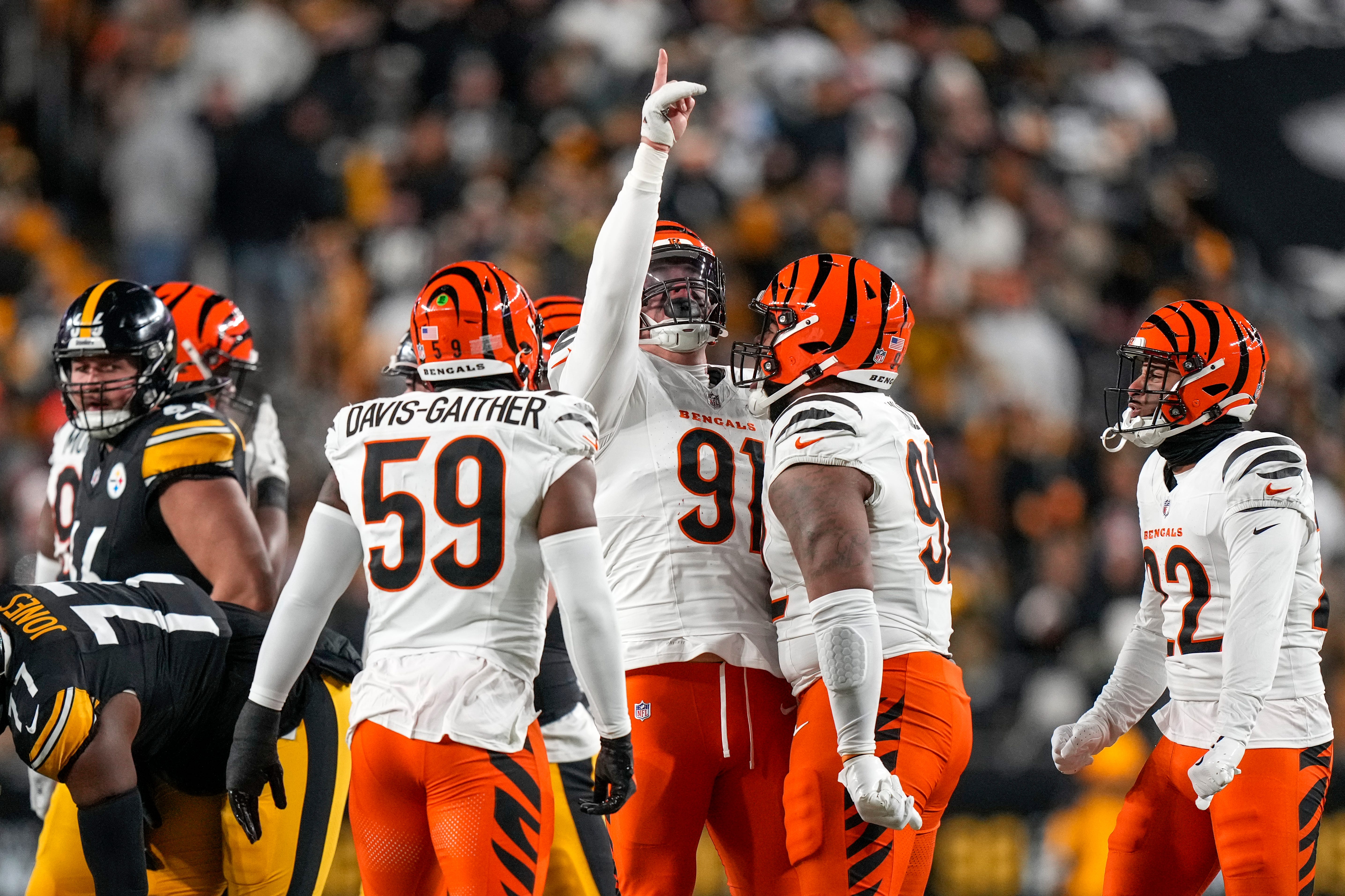 Cincinnati Bengals defensive end Trey Hendrickson (91) celebrates after sacking Pittsburgh Steelers quarterback Russell Wilson (3) in the first quarter of the NFL Week 18 game between the Pittsburgh Steelers and the Cincinnati Bengals at Acrisure Stadium in Pittsburgh on Saturday, Jan. 4, 2025.  