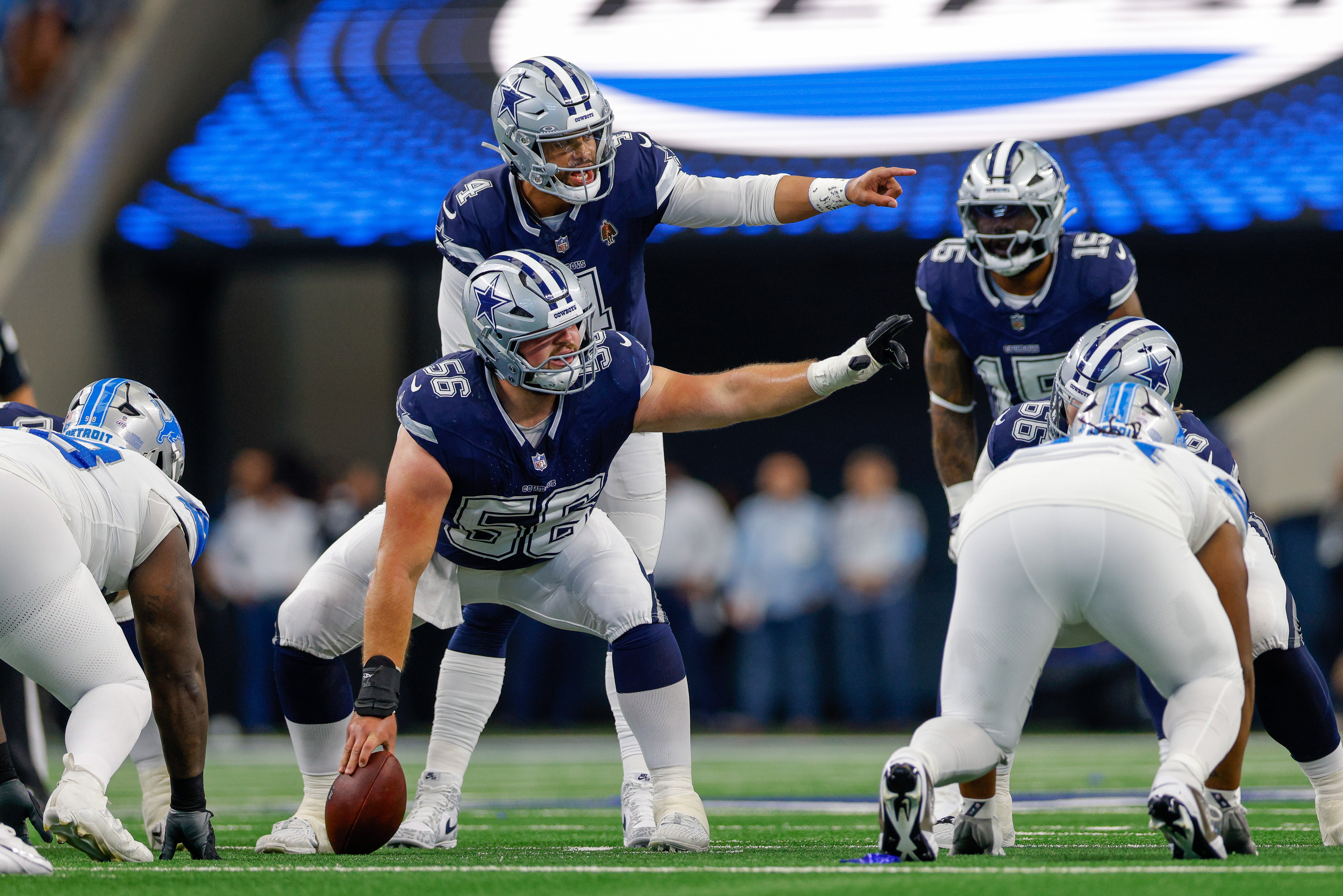 Dallas Cowboys centerCooper Beebe (56) and quarterback Dak Prescott (4) signal prior to the snap during the first quarter against the Detroit Lions at AT&T Stadium.