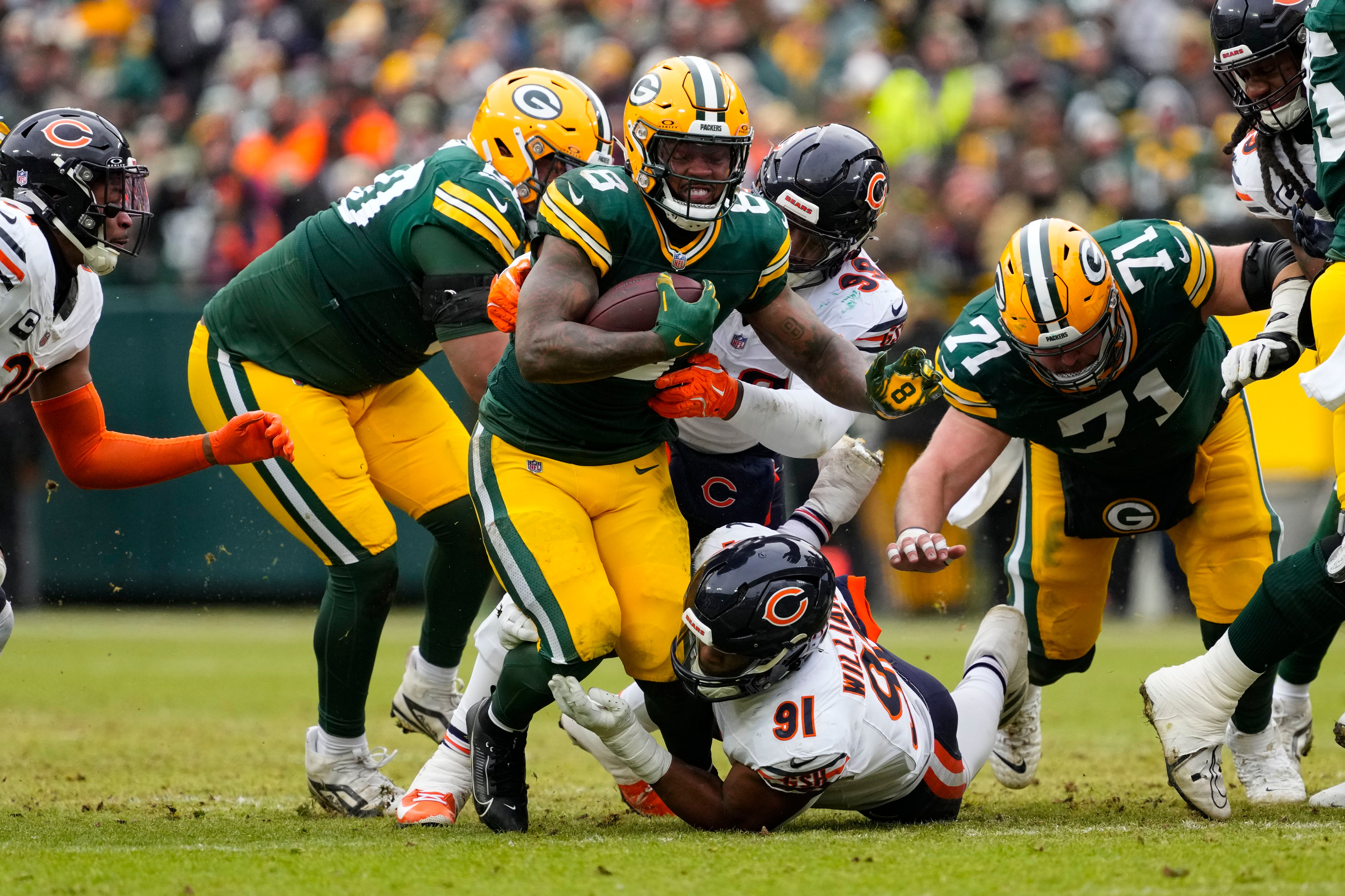 Green Bay Packers running back Josh Jacobs (8) rushes with the football during the second quarter against the Chicago Bears at Lambeau Field.