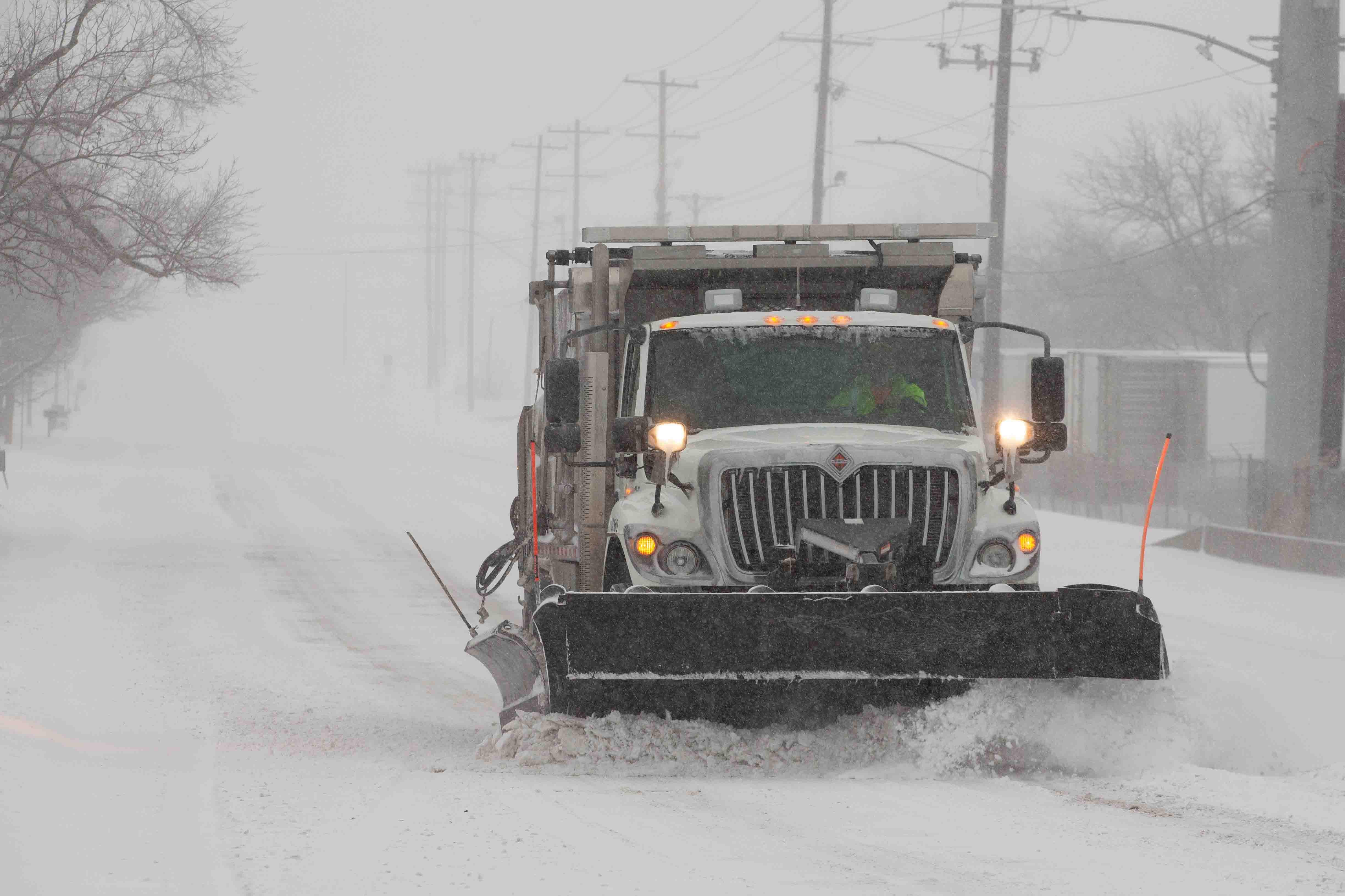 A snowplow with Shawnee County Public Works clears part of S.E. Sixth Avenue on Sunday, Jan. 5, 2025.