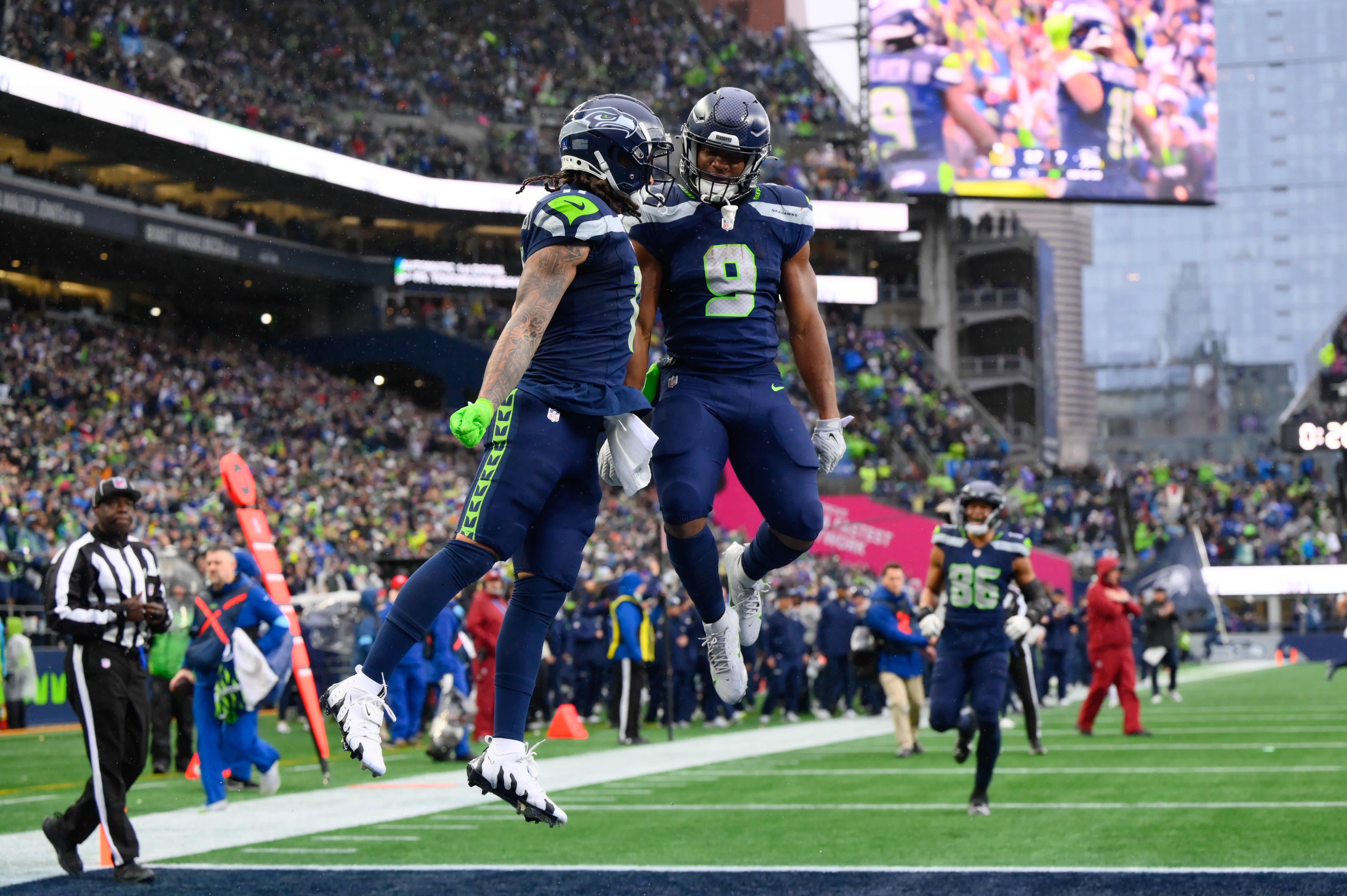 Seahawks wide receiver Jaxon Smith-Njigba (11) and running back Kenneth Walker III (9) celebrate after Jaxon Smith-Njigba scored a touchdown against the Vikings.